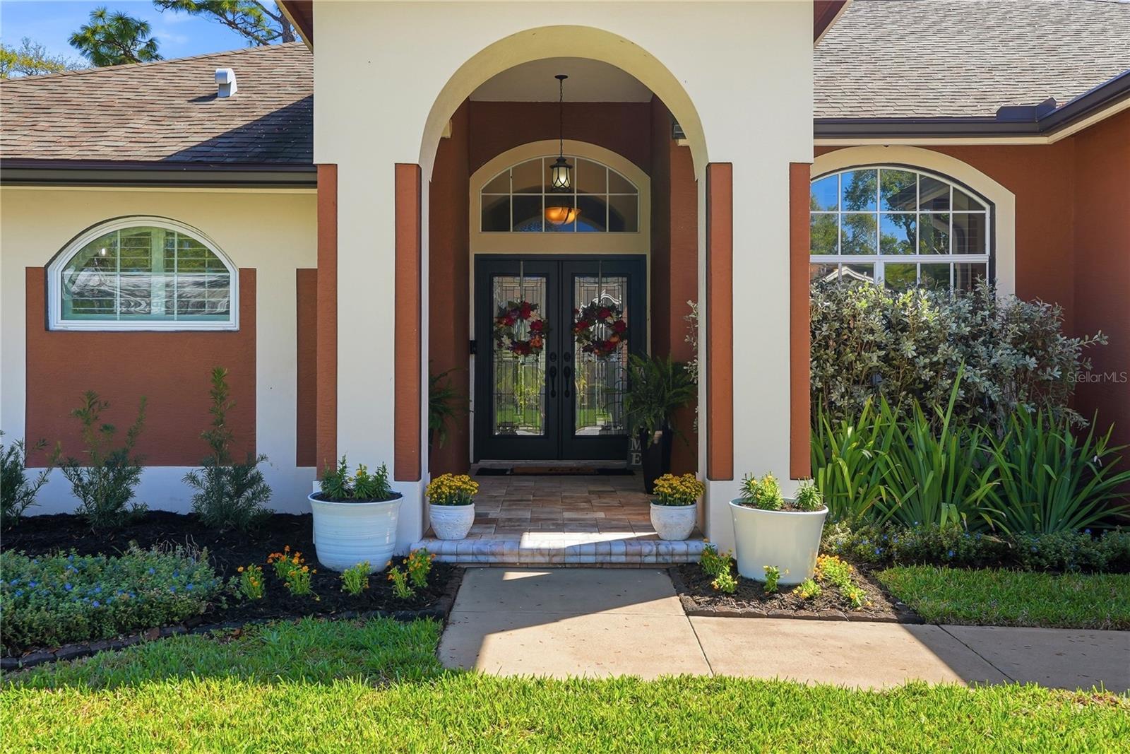 Inviting front porch entry way with elegant double front doors