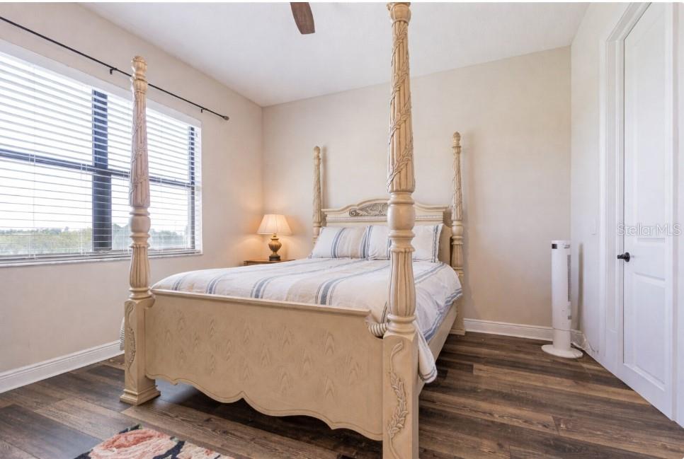Secondary guest bedroom with backyard views