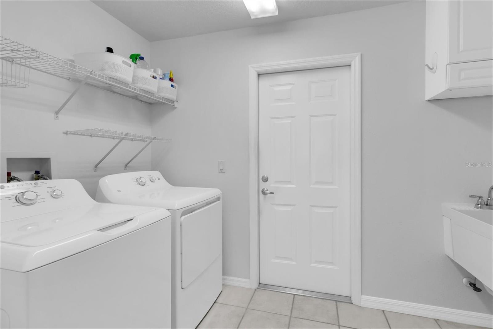 Laundry Room with utility sink and cabinet