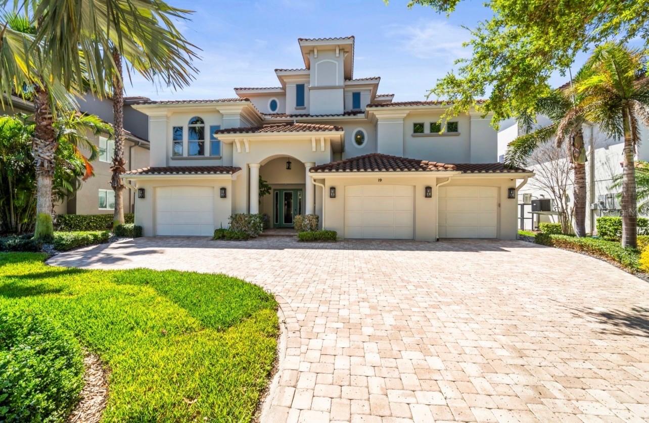 Gorgeous waterfront estate with a grand architectural presence, massive 5 car split garage & professionally designed landscaping