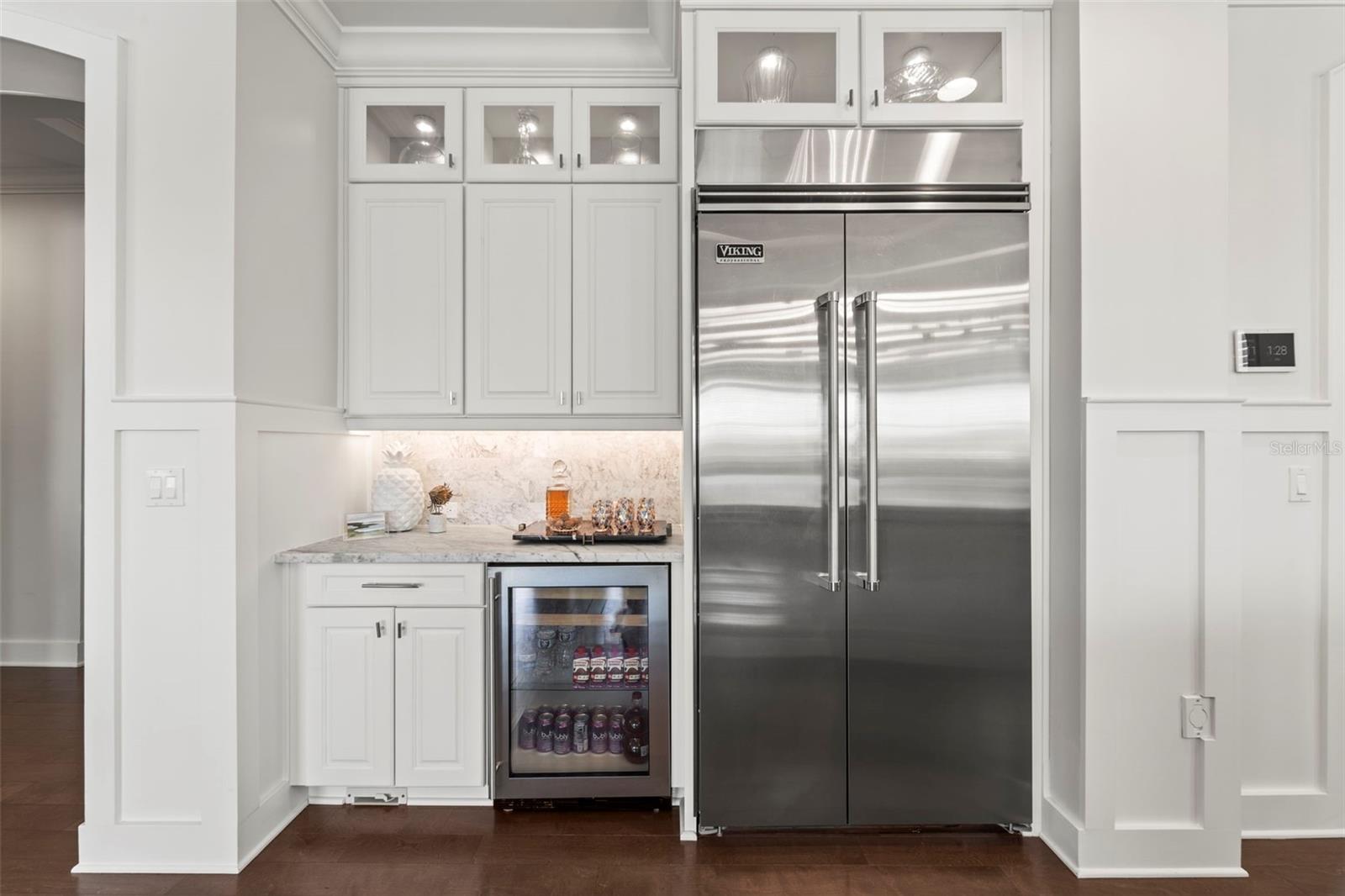 Custom dry bar with built-in Viking side by side refrigerator/freezer and wine fridge