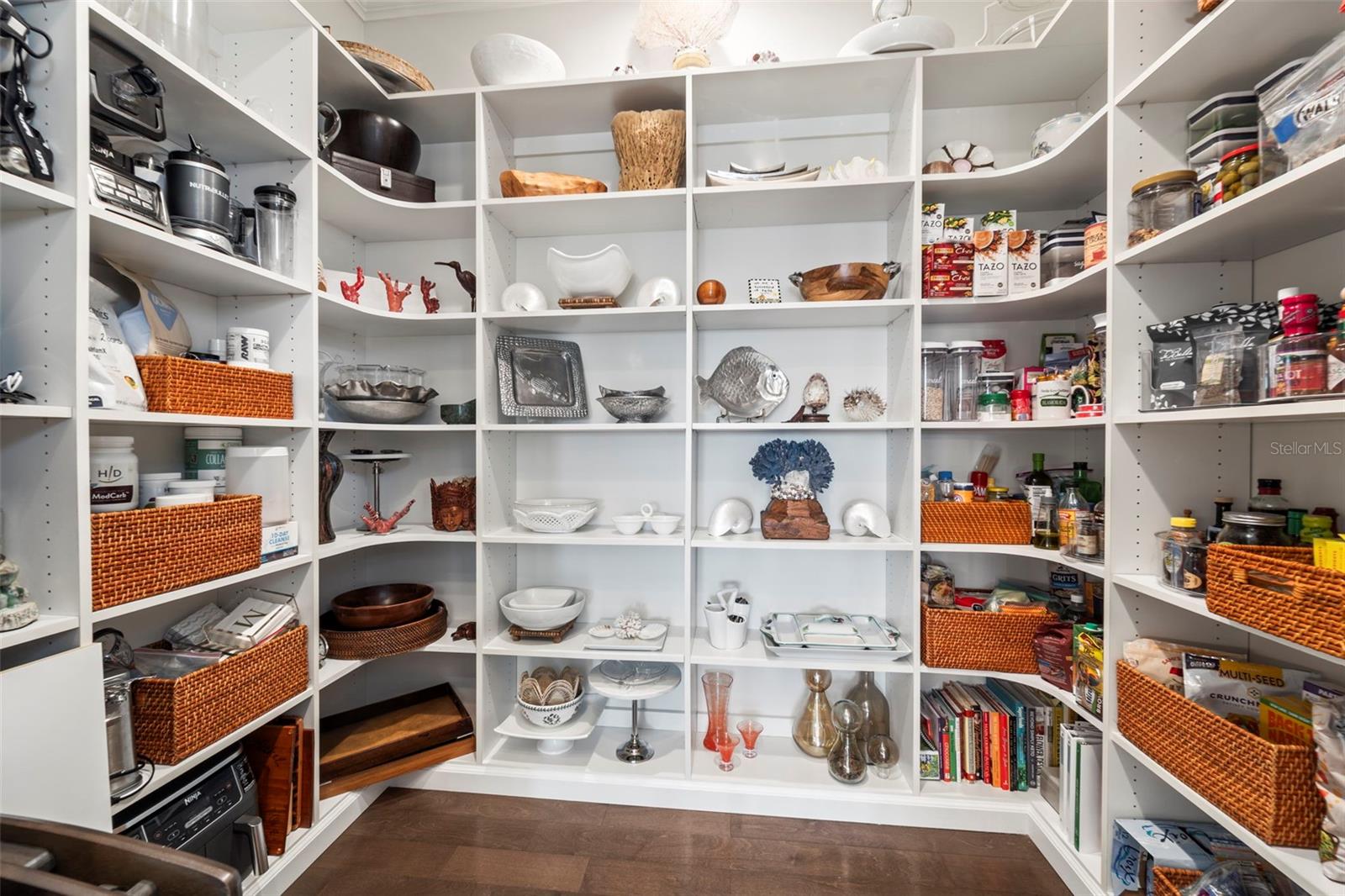 Spacious walk-in pantry with extensive built-in shelving and exceptional storage
