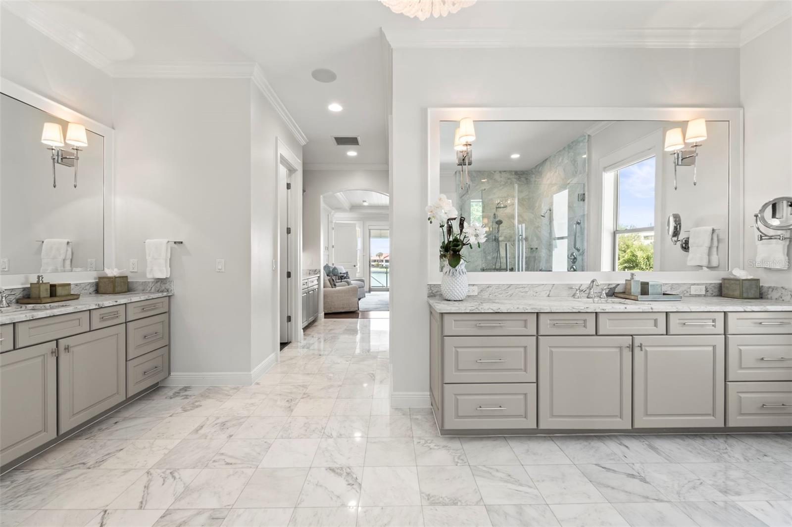 Additional view of the spectacular marble bath with dual vanities facing towards the bedroom.