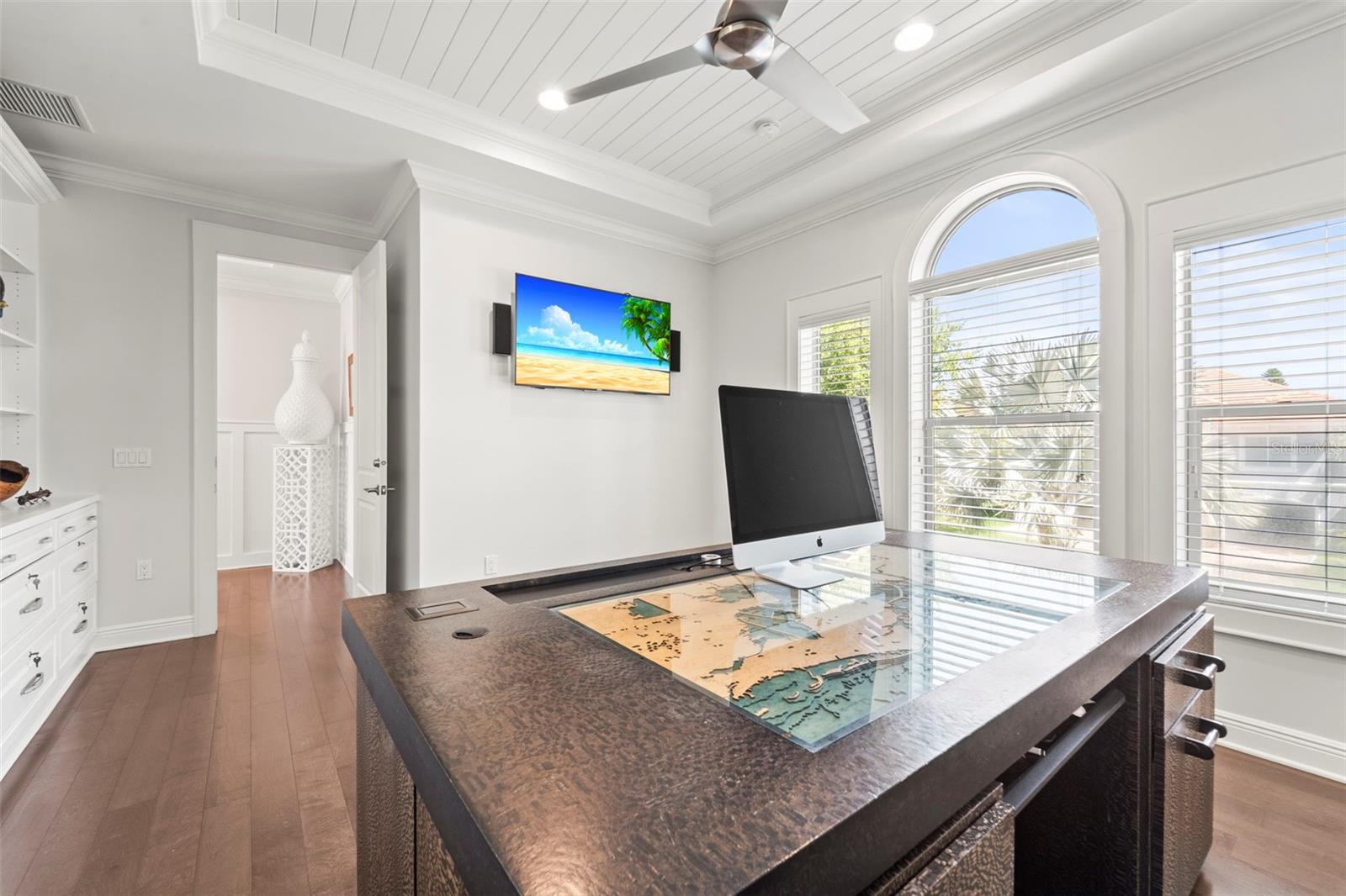 Well-lit home office with expansive windows and abundant natural light.