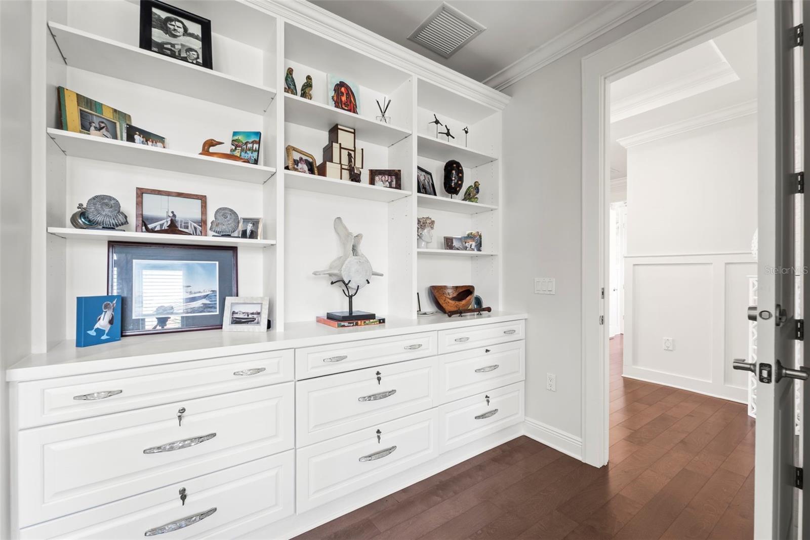 Home office features custom built-in shelving and file cabinets for organized storage.