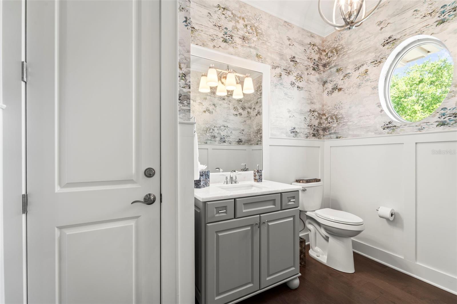 Beautifully designed half bath with designer finishes and linen closet for added storage.