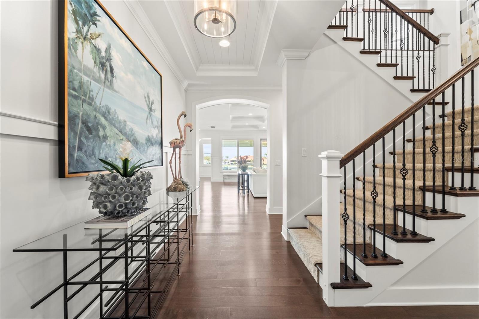 Landing from the ground level leading to the main living floor, which includes the primary suite, kitchen, dining area, office, laundry room, and a spacious lanai accessible from both the living room and primary suite.