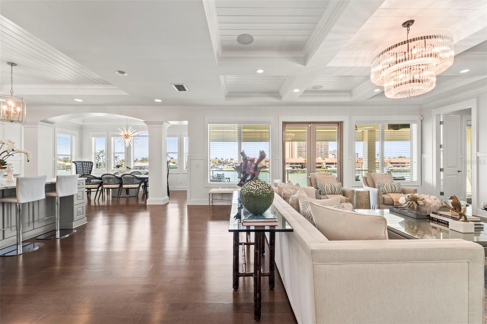 Expansive open living space that moves seamlessly between the living room, dining room, and kitchen flowing to your private outdoor balcony with stunning water views