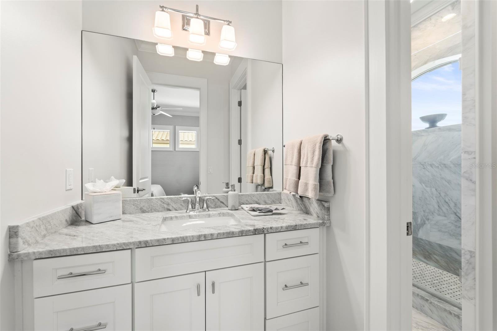 Bedroom 4's private vanity area within the Jack-and-Jill bathroom shared with Bedroom 3.