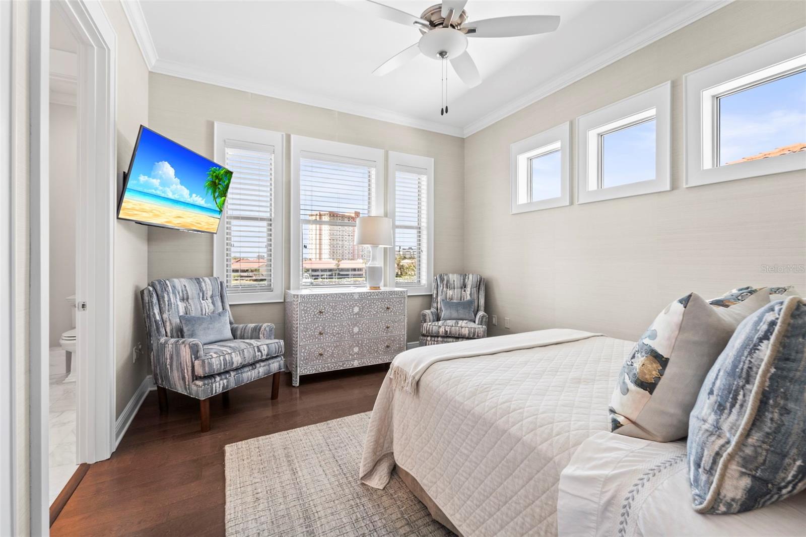 Bedroom 4 with water views, private vanity, and access to a shared Jack-and-Jill bath.