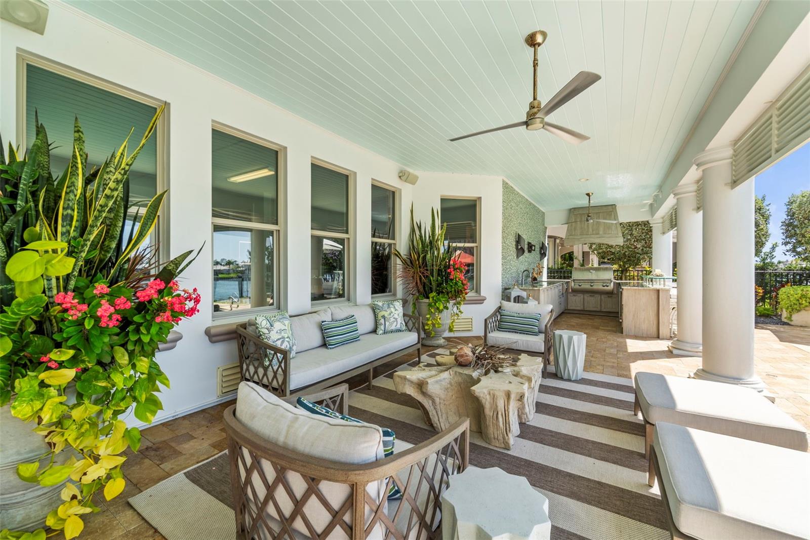 Expansive poolside lanai featuring a fully equipped outdoor kitchen and inviting entertaining space.