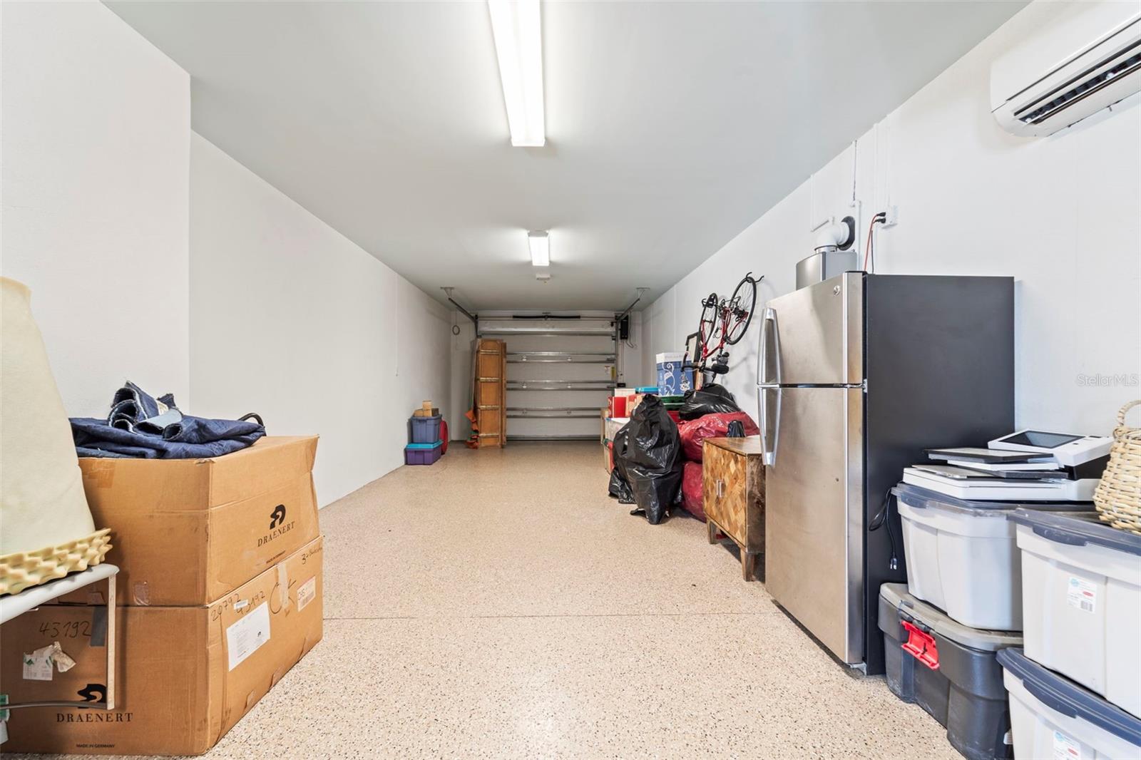 Split garage with ample storage space and custom cabinets
