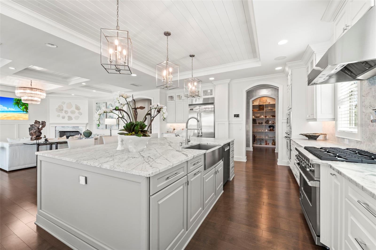 Amazing gourmet kitchen with custom cabinetry, marble countertops, expansive prep space, and open layout