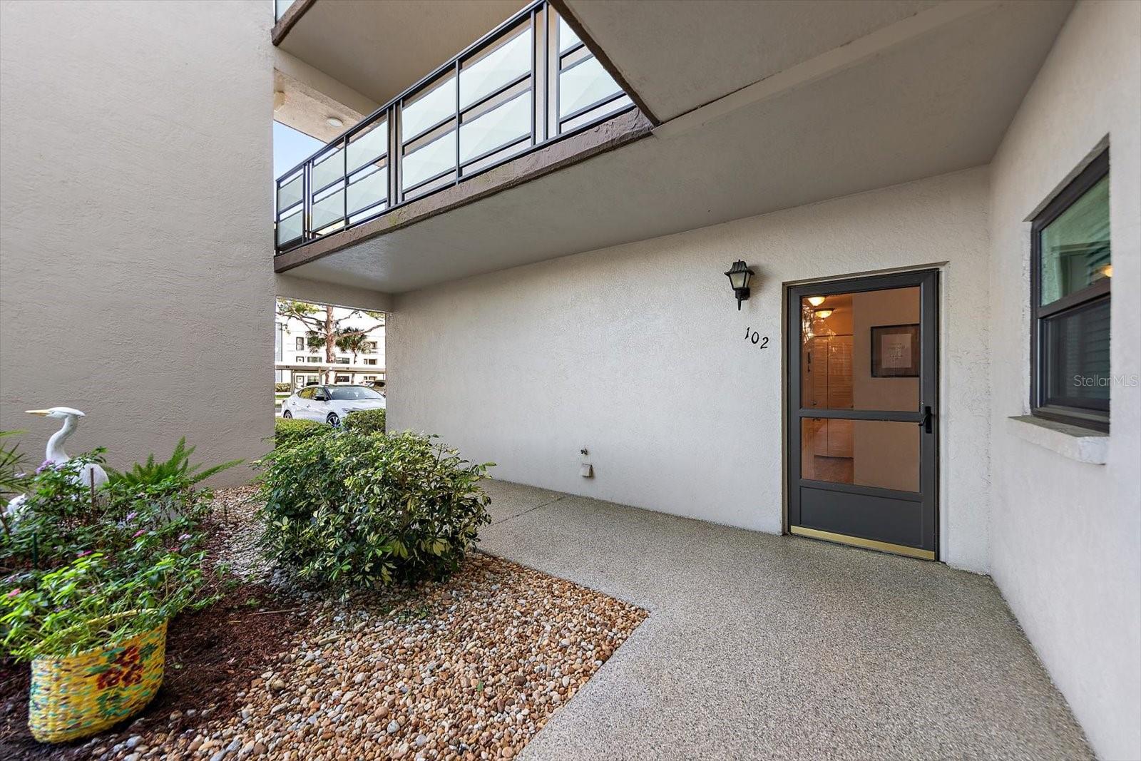 Gorgeous covered front door with garden view