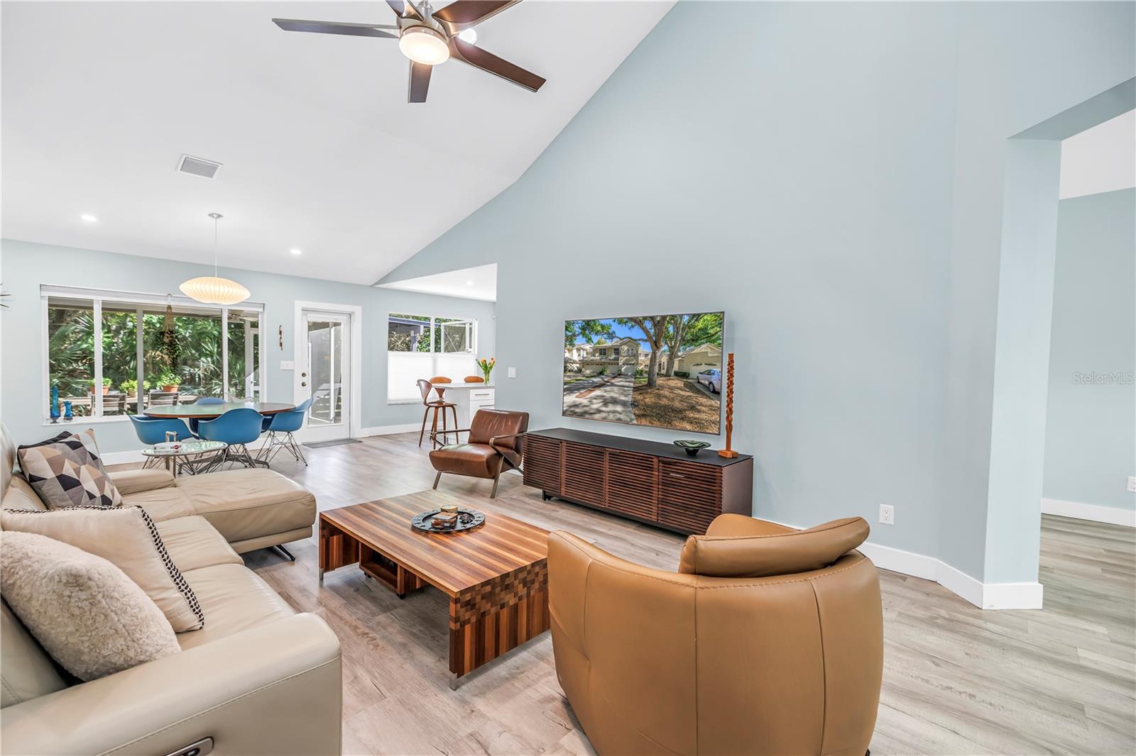 Spacious Living Room with Vaulted Ceilings and Great Light and Fan Fixtures.