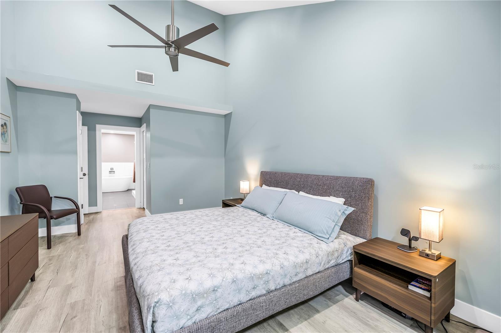 Primary Bed Bath Suite with High Vaulted Ceiling and pleasing Colors.