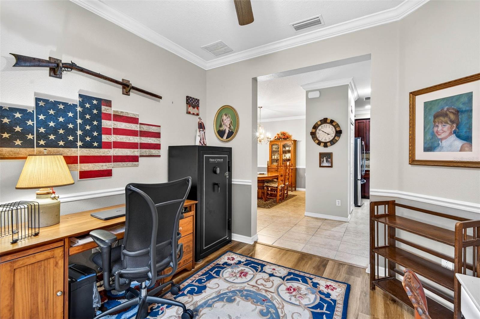 Office with crown molding, chair rail and crown molding. Flooring is luxury vinyl plank.