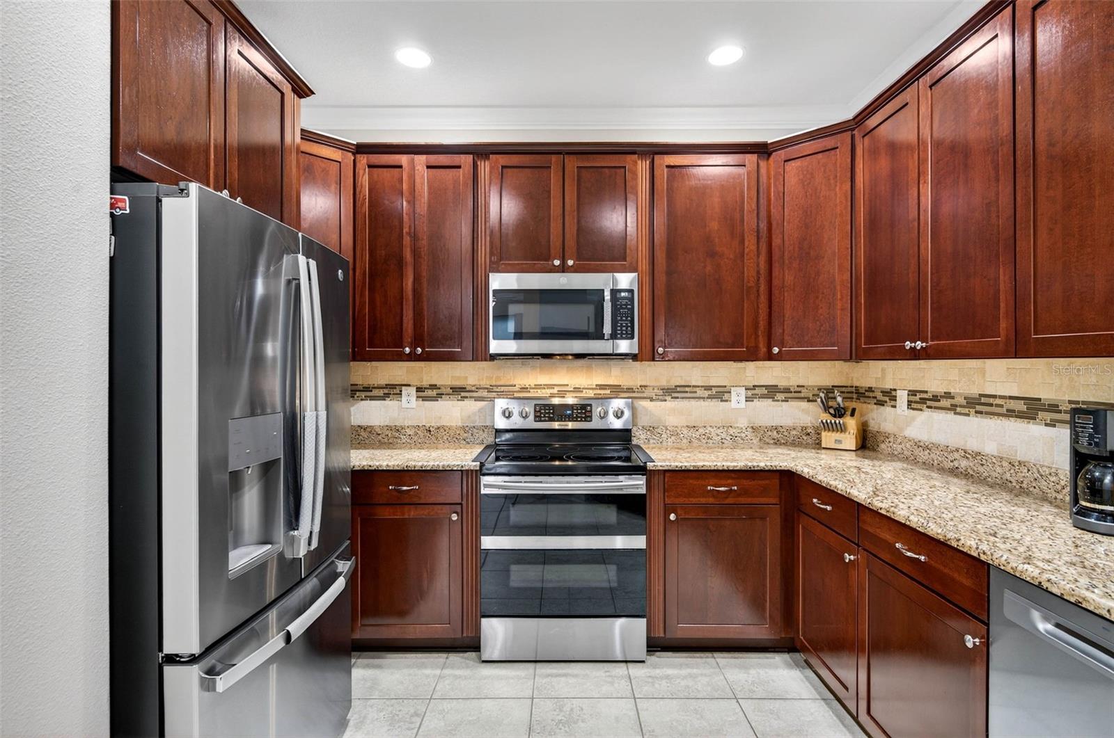 All stainless steel appliances convey. Plenty of cabinet space and countertop space. Decorative backsplash is a nice touch.