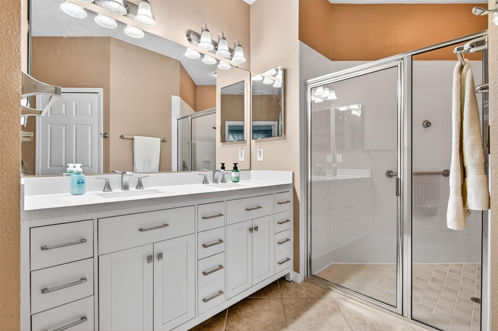 Primary bathroom with new, dual sink vanity. Walk in shower with Rain Shower Head