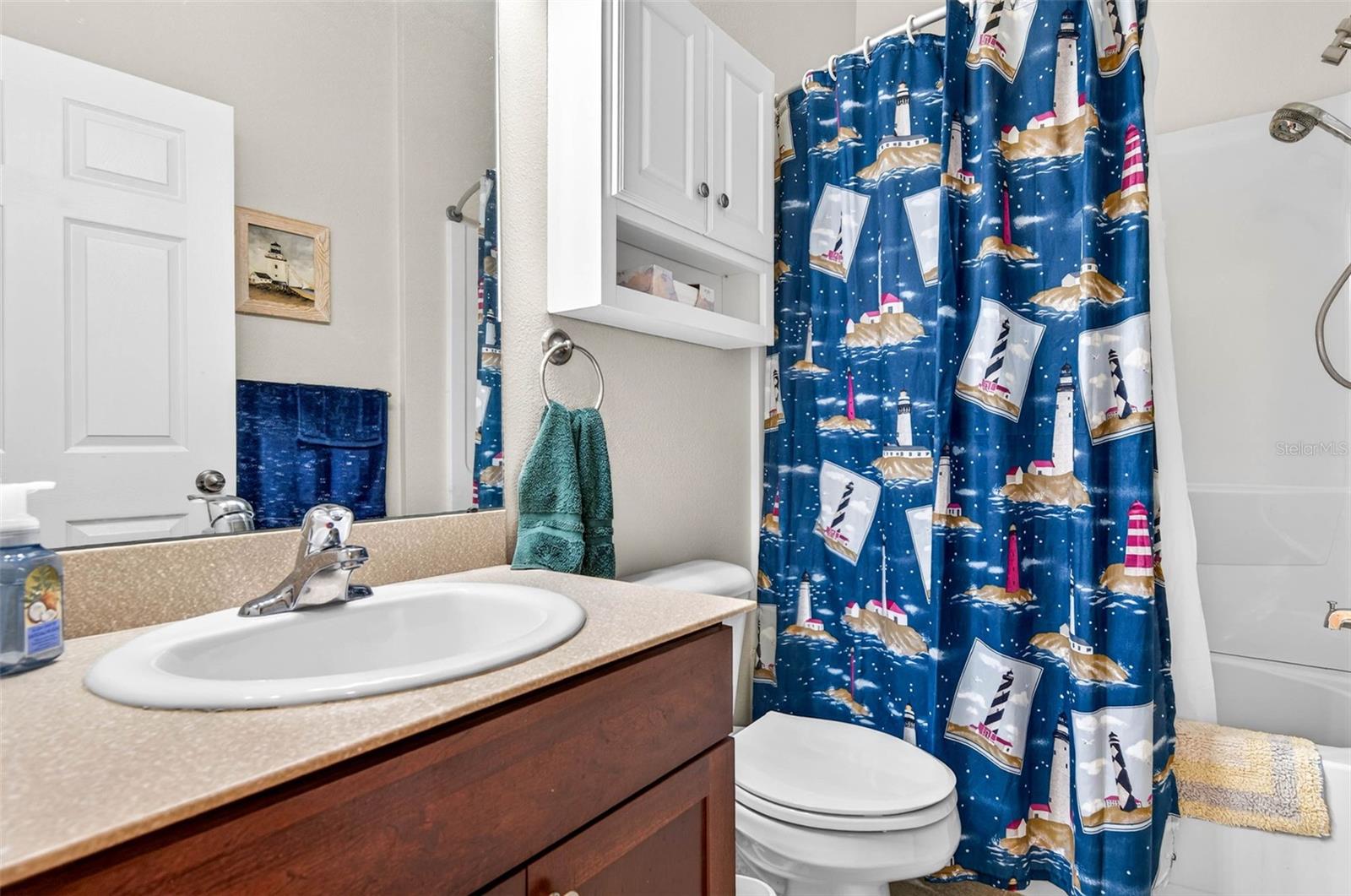 Secondary bathroom with removable showerhead. Comfort height vanity.