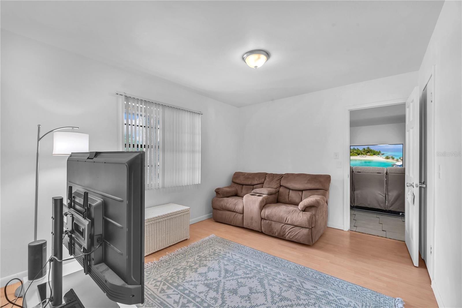 Secondary Bedroom currently staged as sitting room has a walk-in closet.