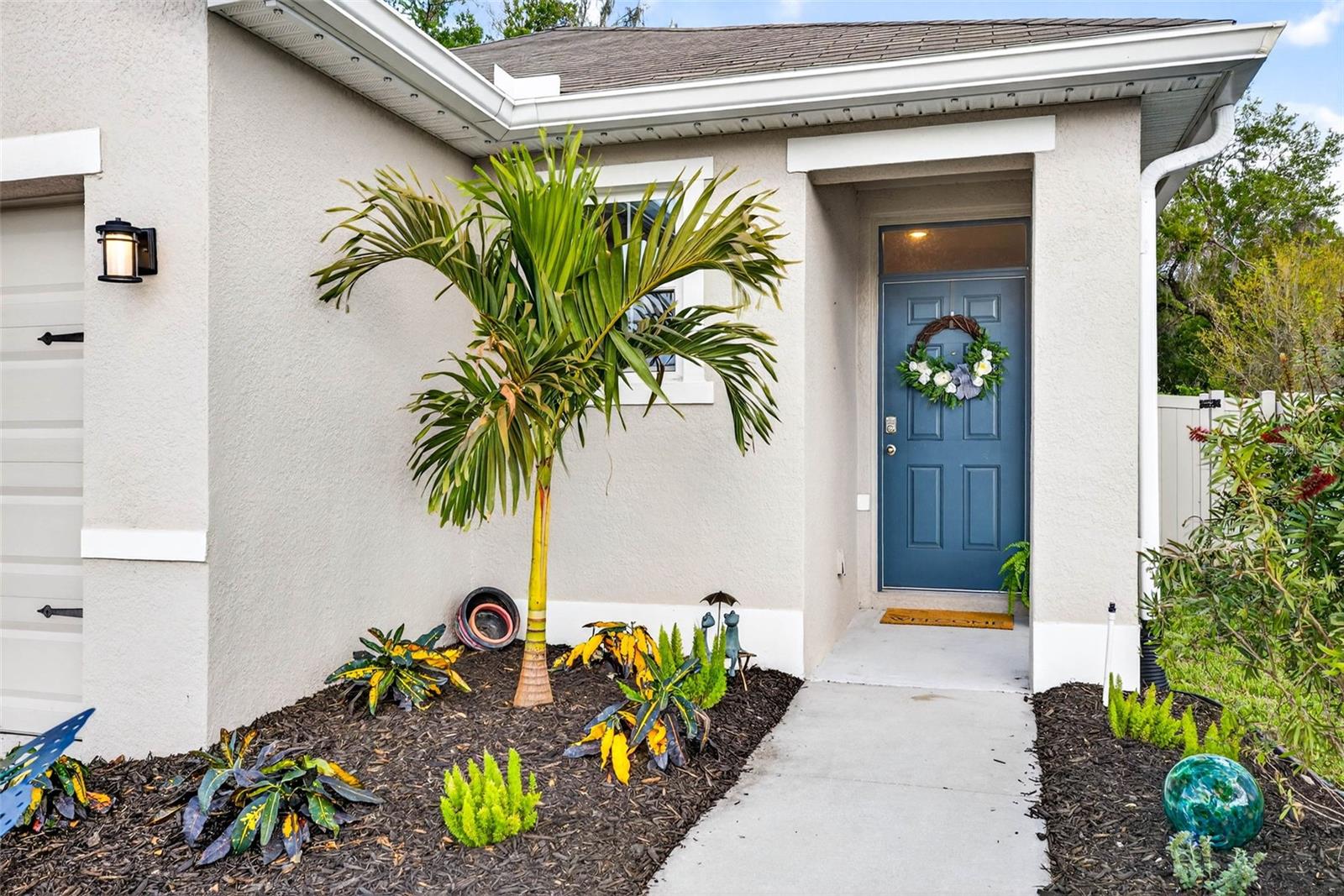 Fresh new landscaping greets your entryway.