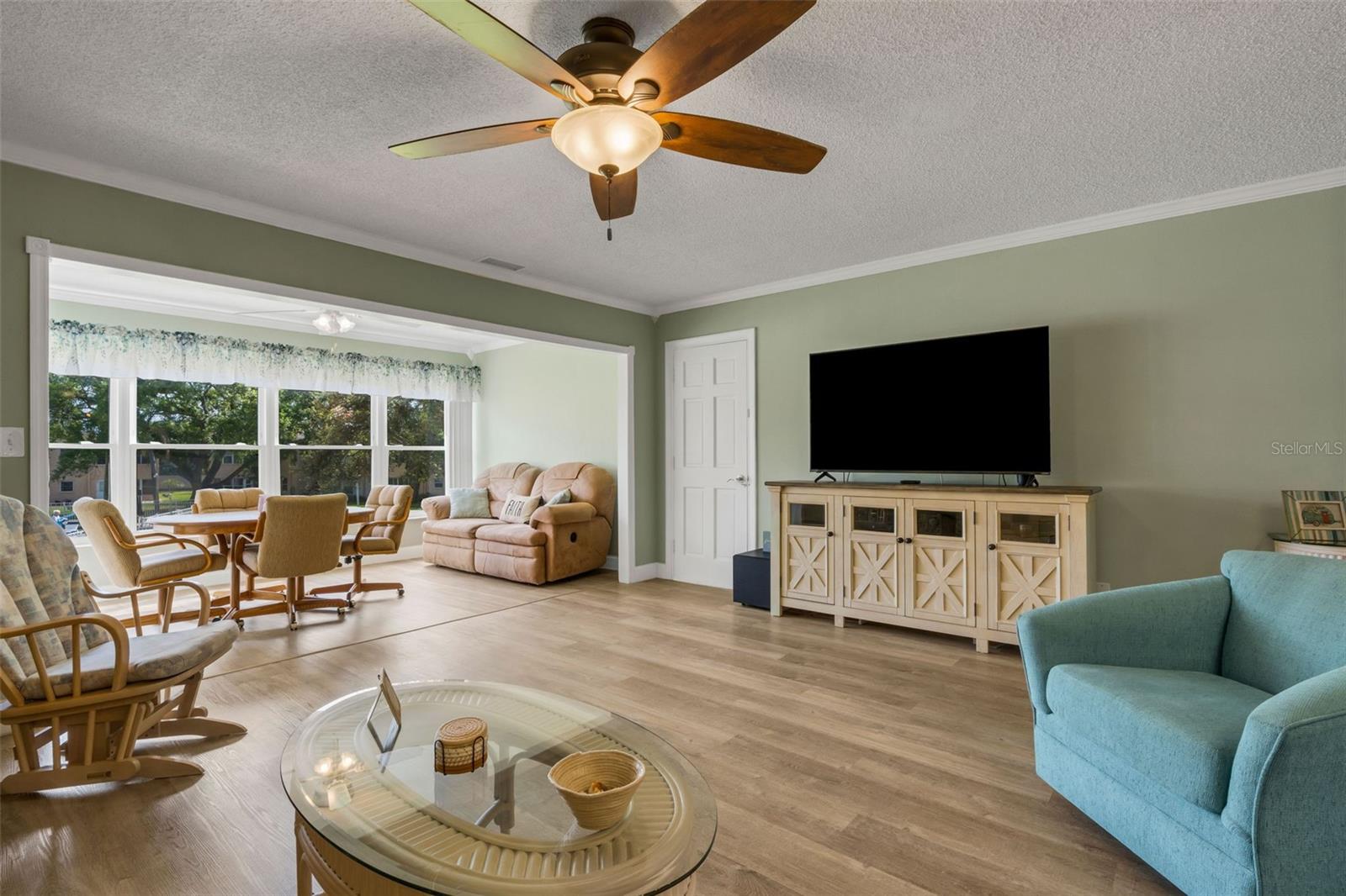 Living Room and Florida Room. Note the Pedestrian Door leading Out to the Stairway Down to the Clubhouse and Pool