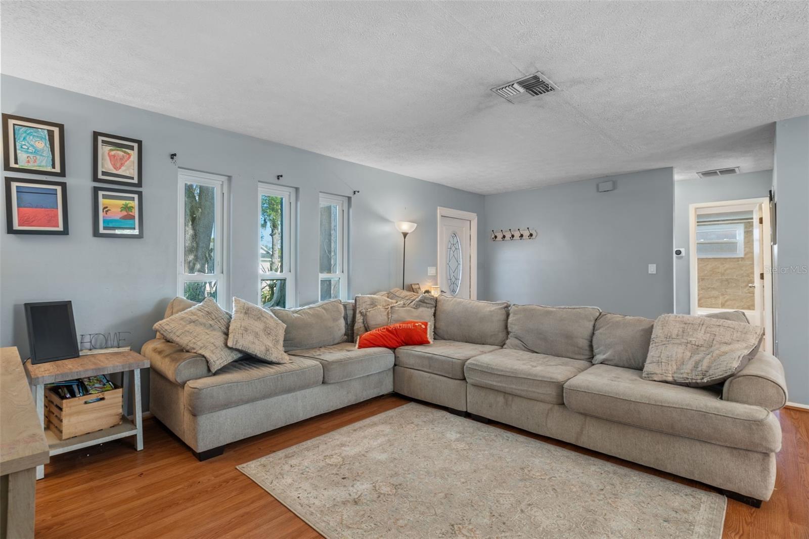 living area into hallway with secondary bedrooms and bath