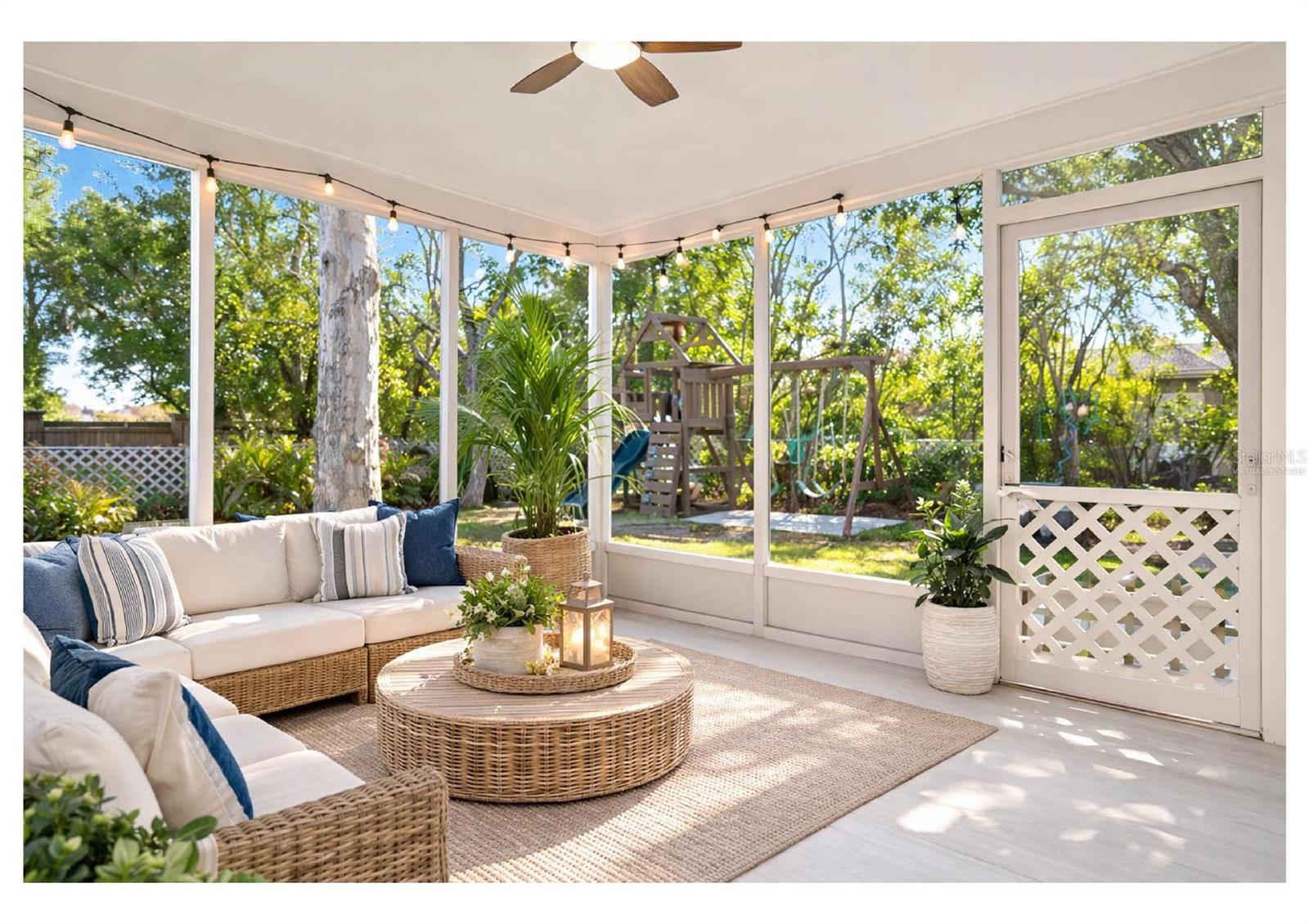 Screened lanai overlooking the backyard. Furniture shown is virtually staged.