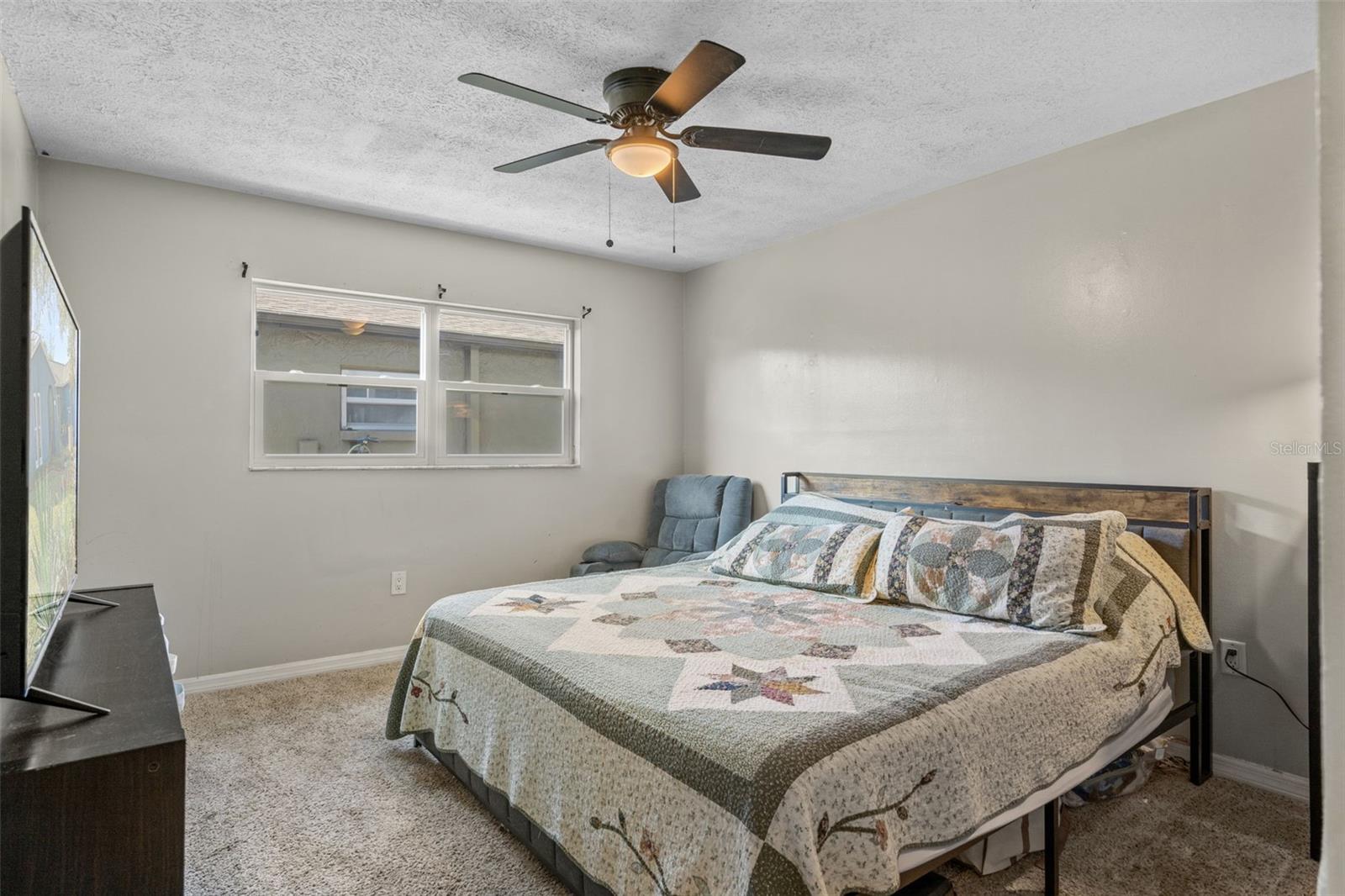 Primary bedroom with natural light and closet storage.