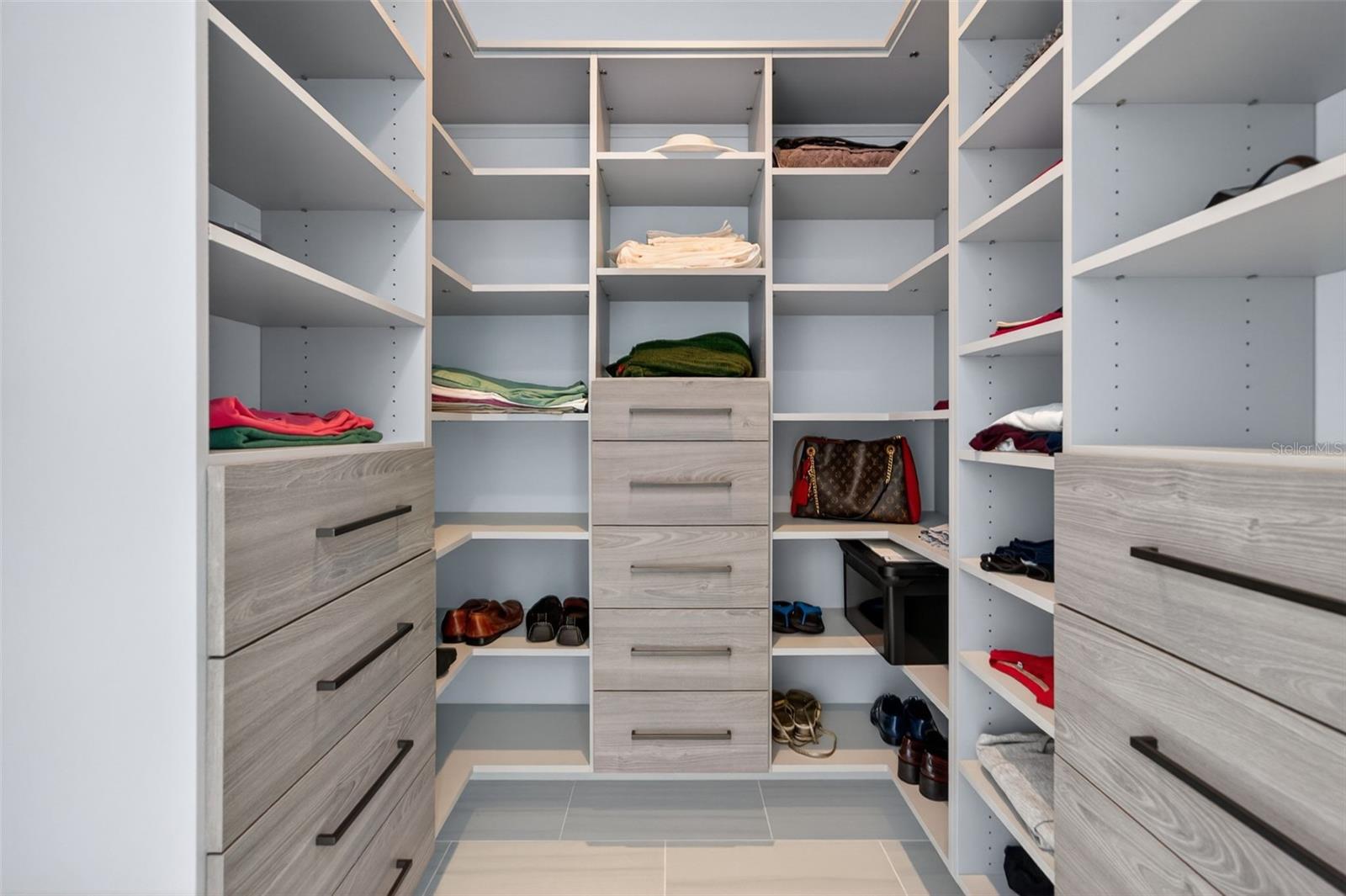 Two walk in closets with custom built ins