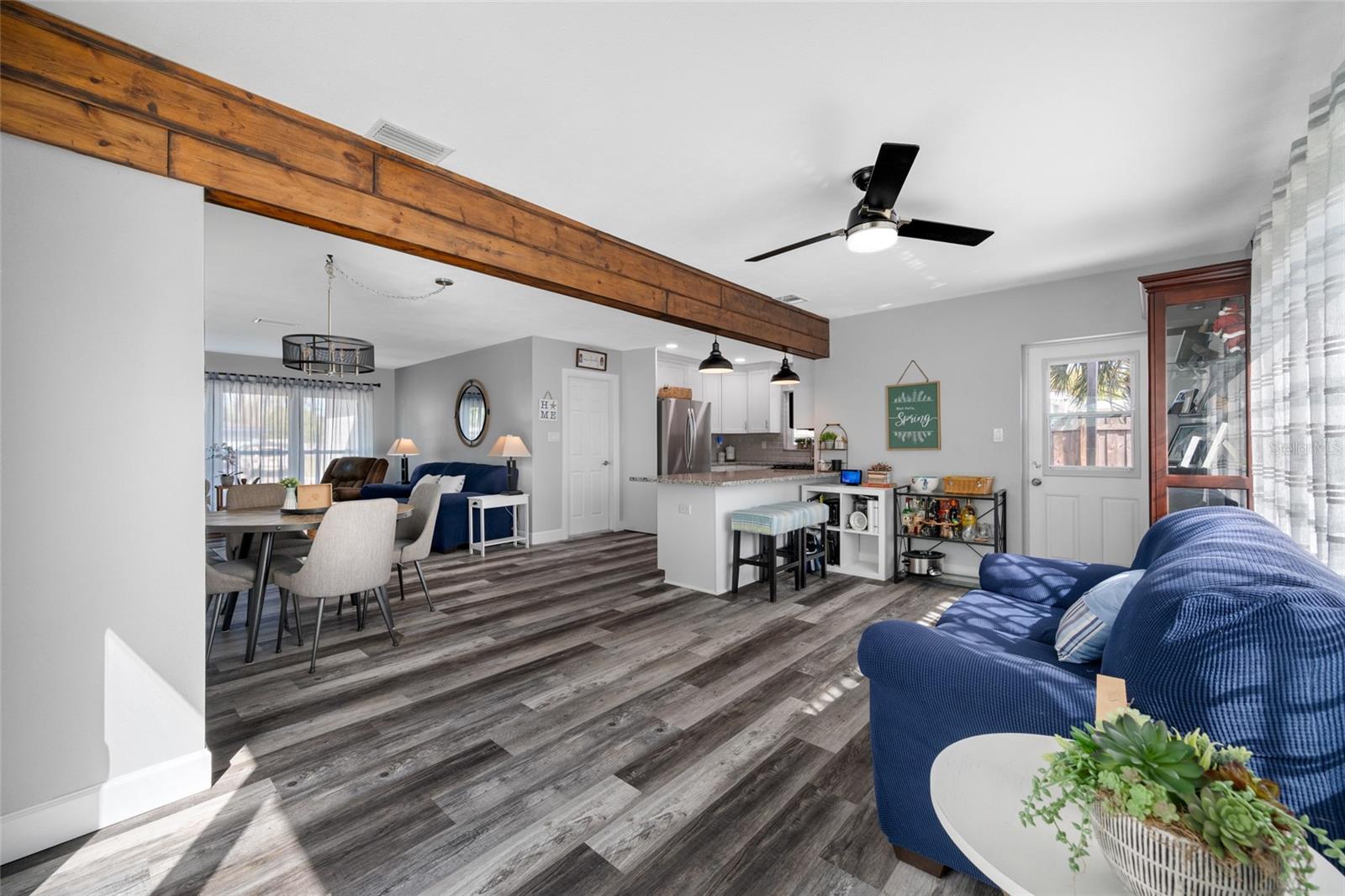 Family Room area with triple windows and slider opening our to the pool deck