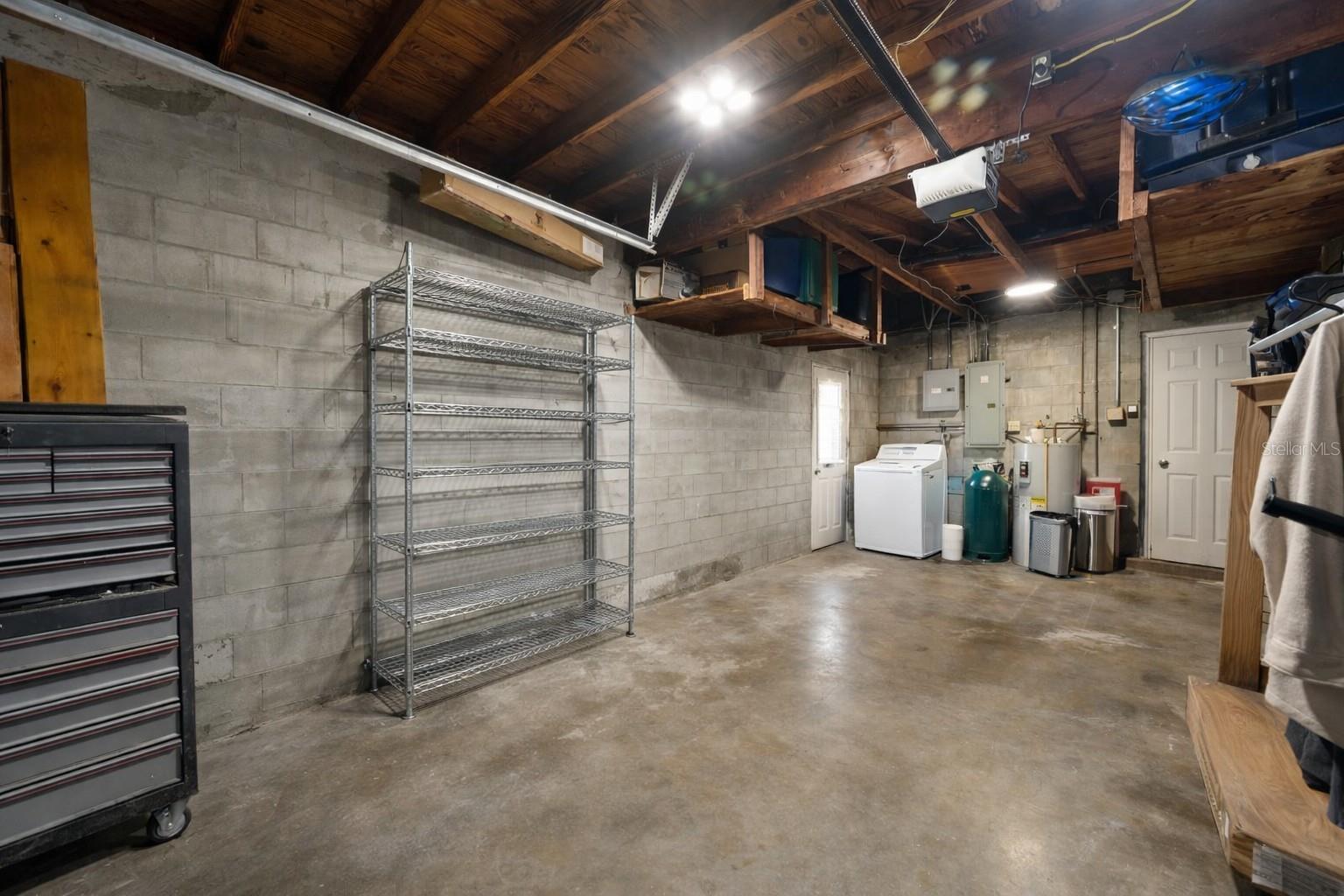 Oversized 1 car garage with Laundry Area, and room for tools & workshop.