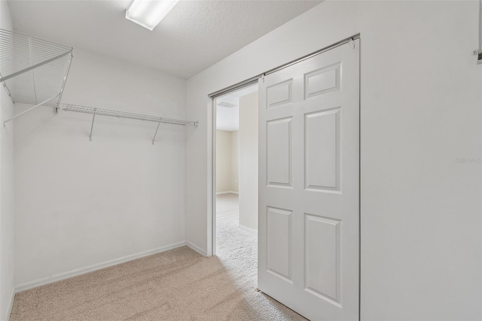 Primary bedroom walk-in closet