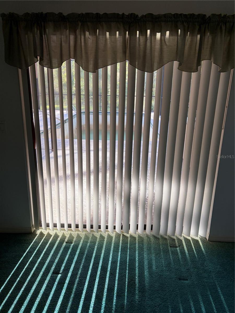 living room and also an entrance into pool area