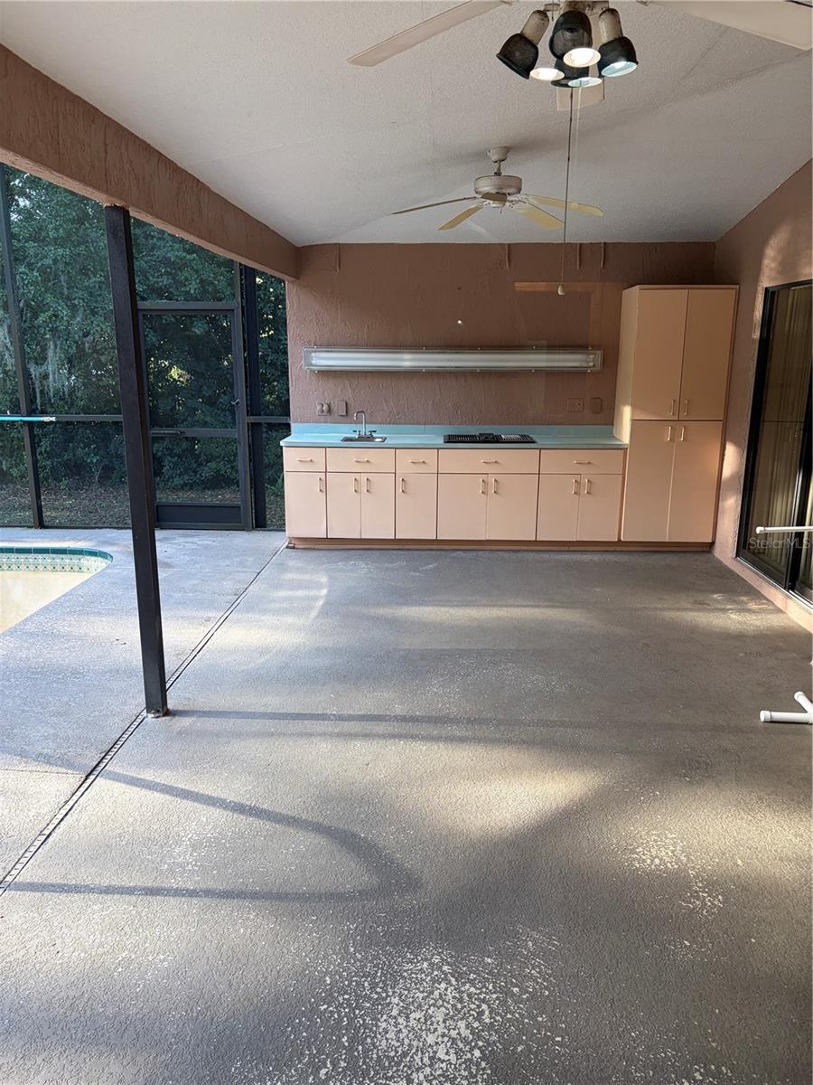 outside kitchen, sink, stove, cabinets, countertop