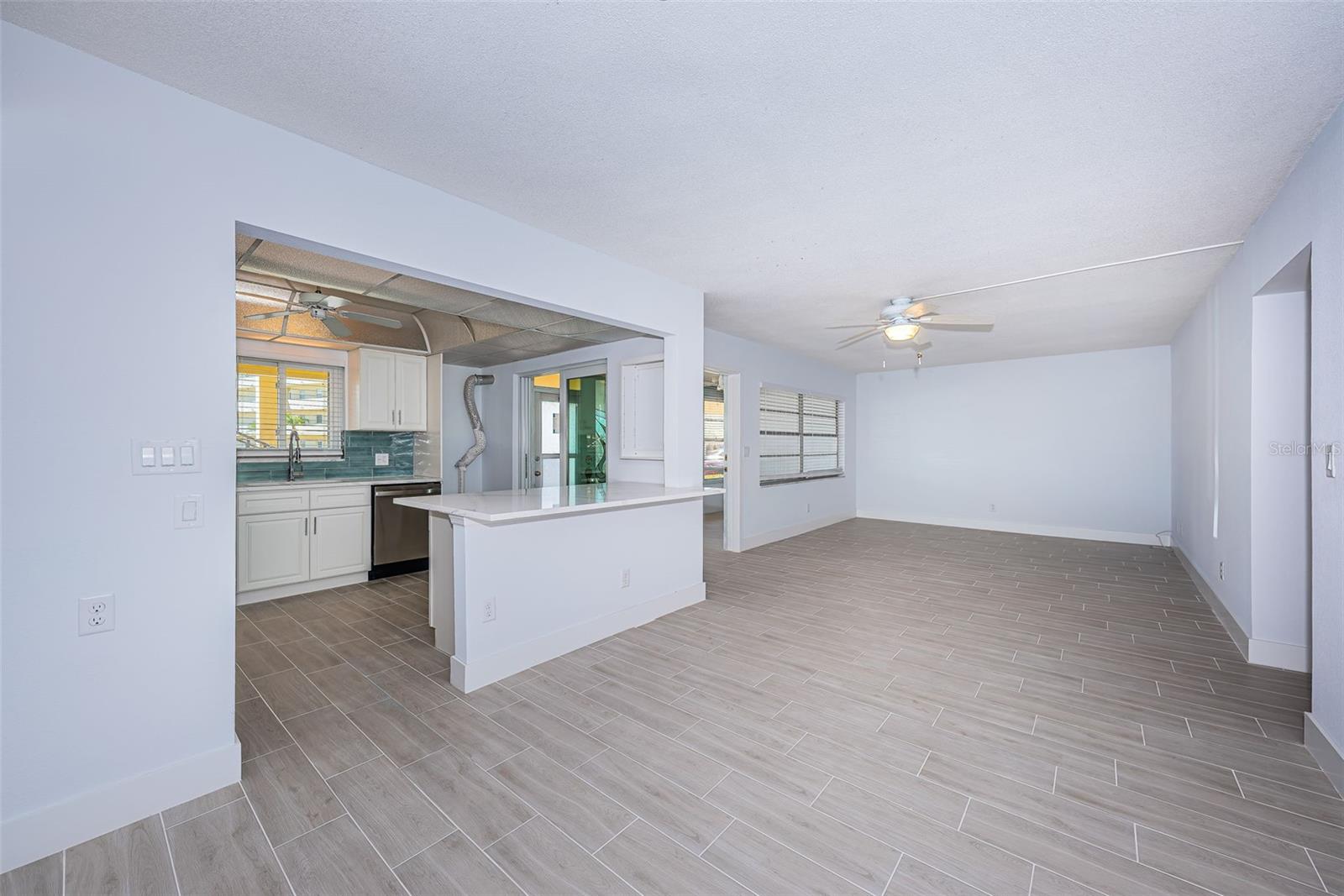 Dining room and Living room showing kitchen and breakfast bar.