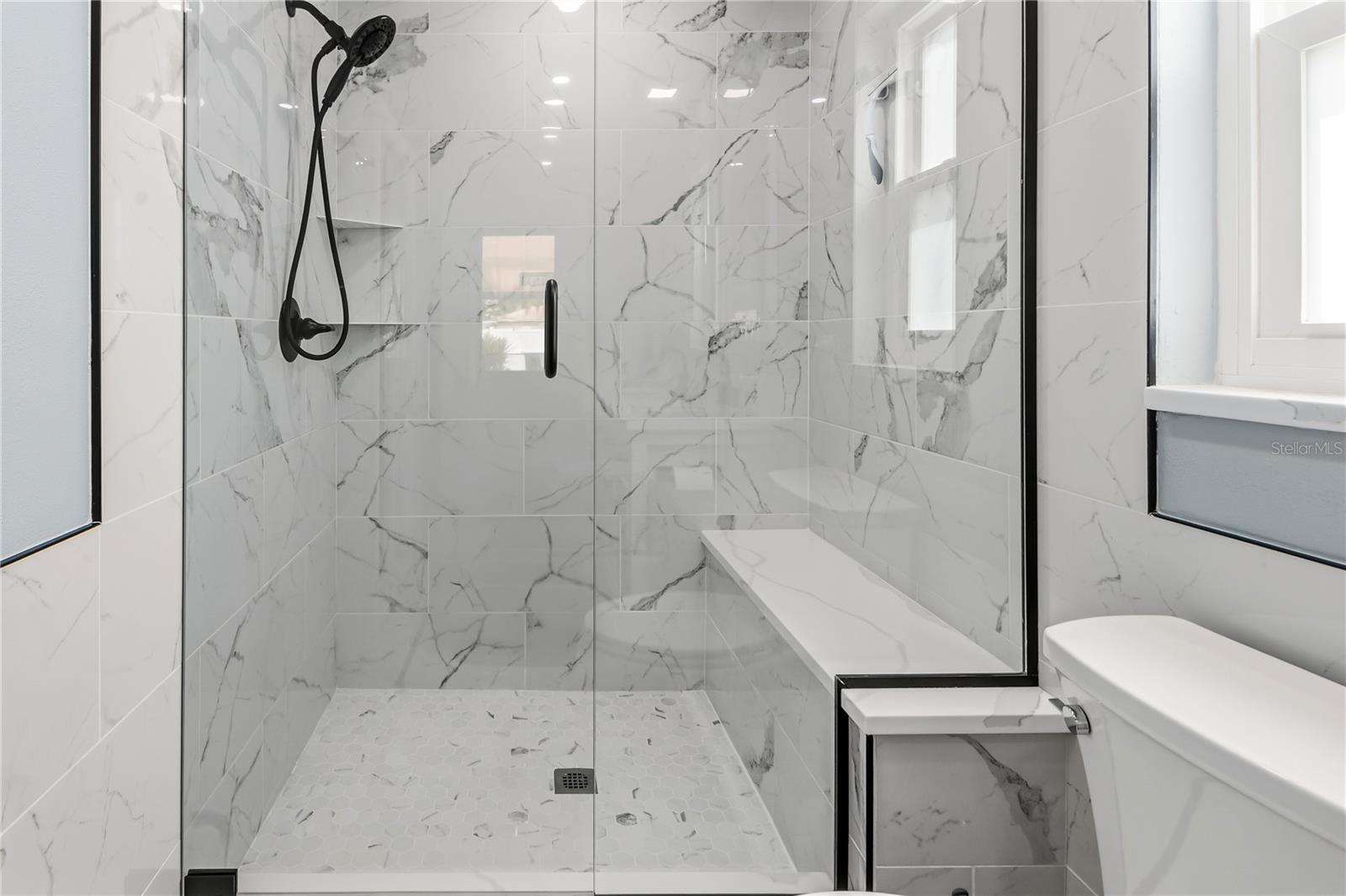 Primary bathroom seamless glass enclosure