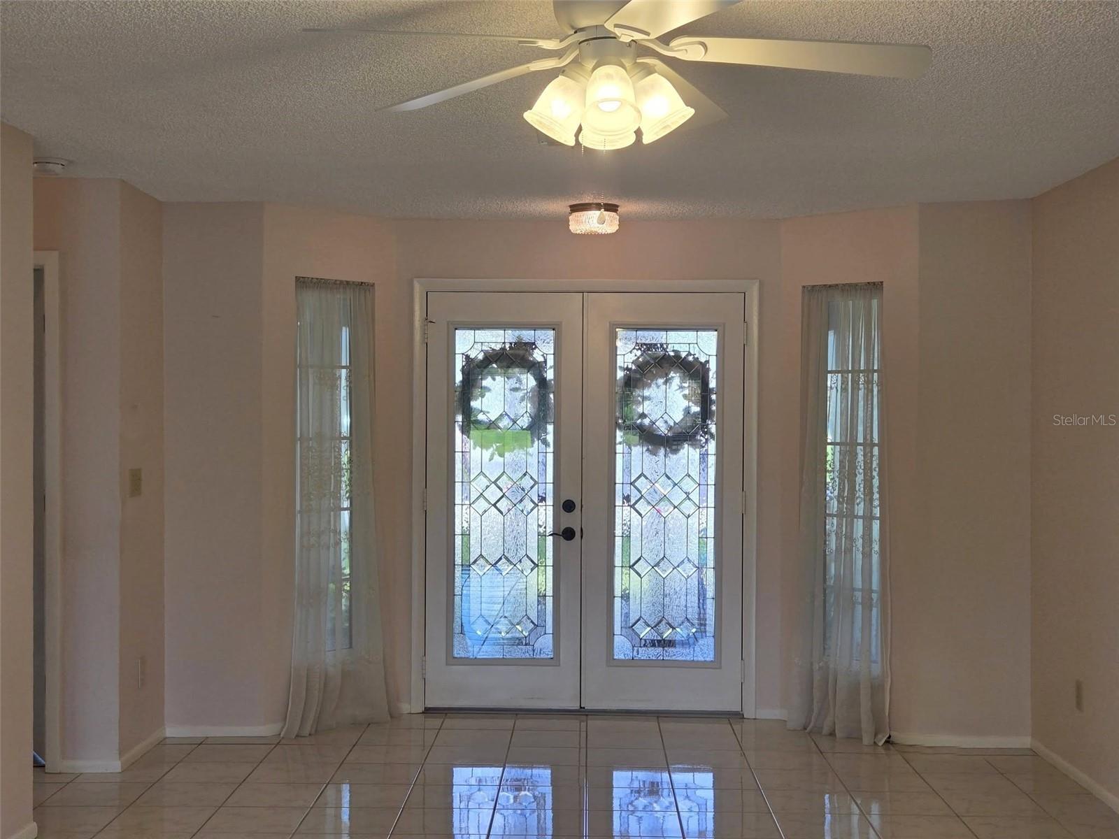 Gracious foyer with double doors & sidelights~
