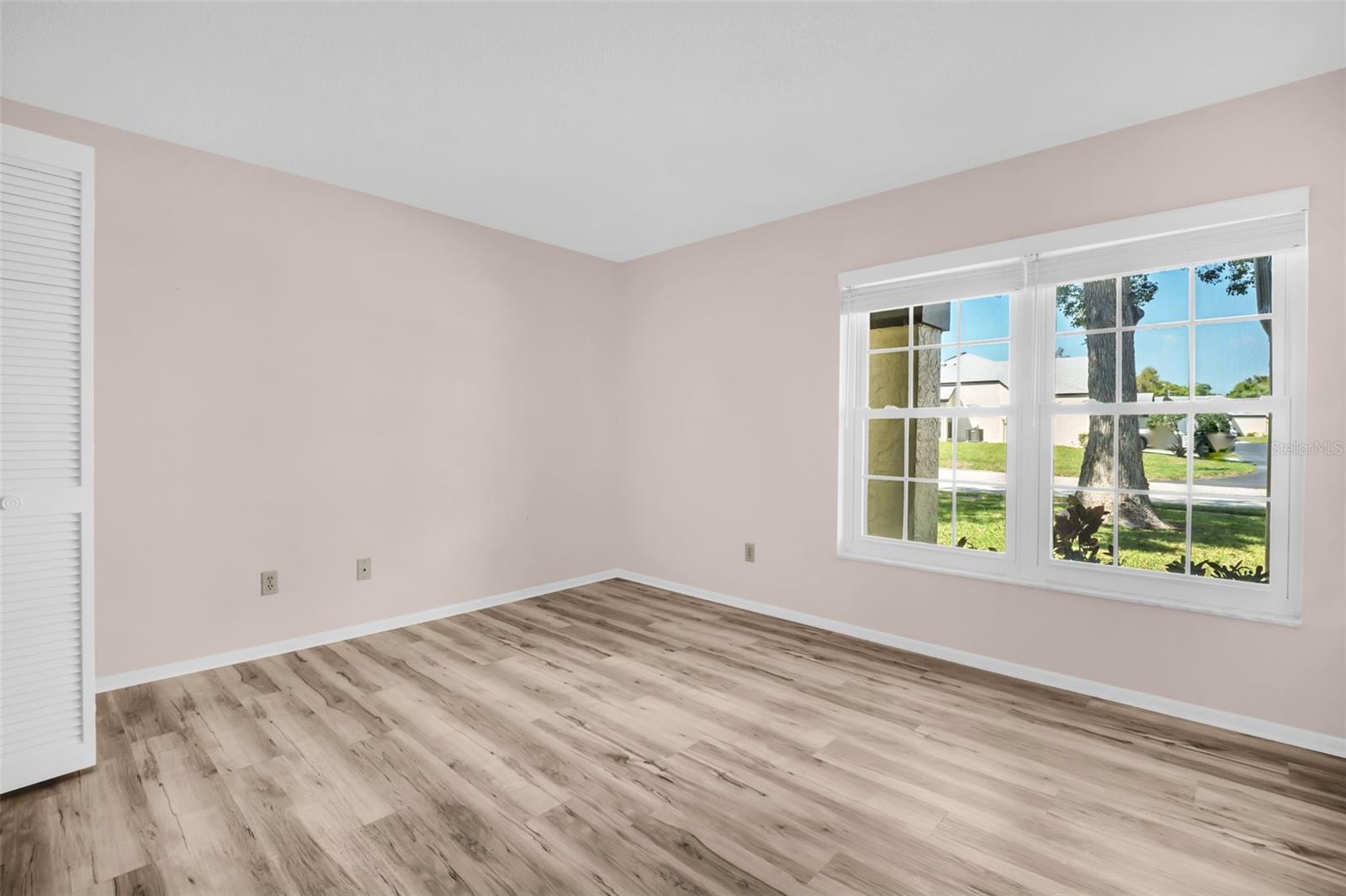 Secondary bedroom in front has newer vinyl plank flooring & updated windows~