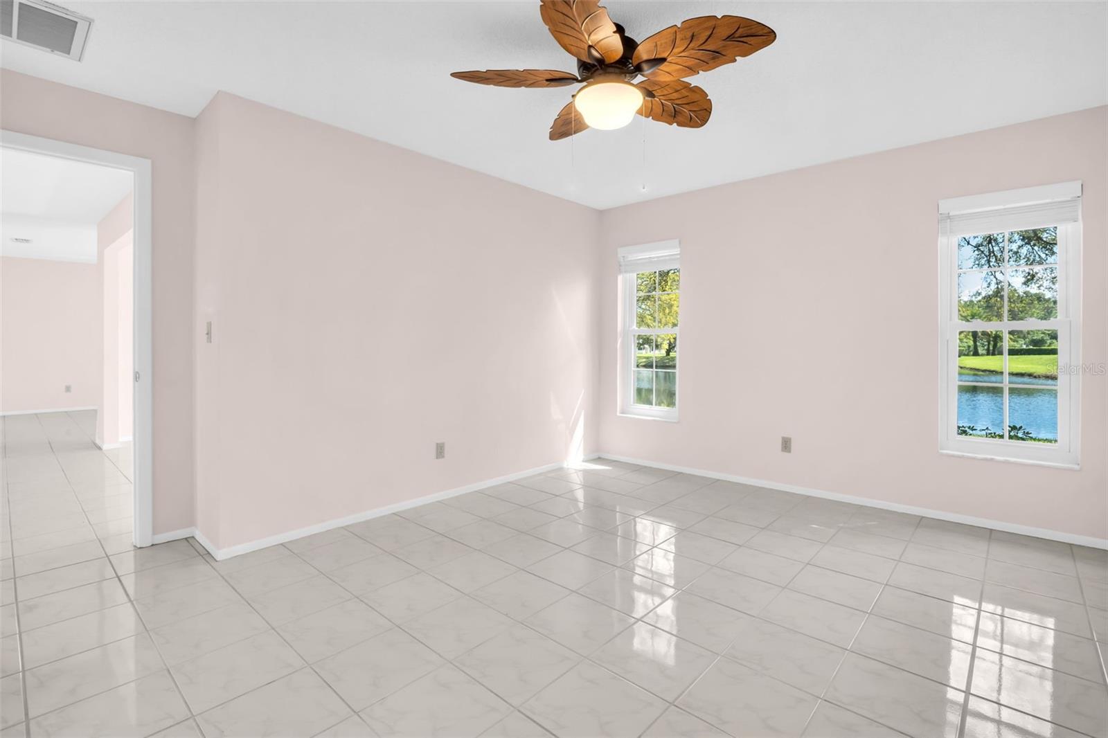Primary bedroom in in back with updated view windows & ceiling fan~