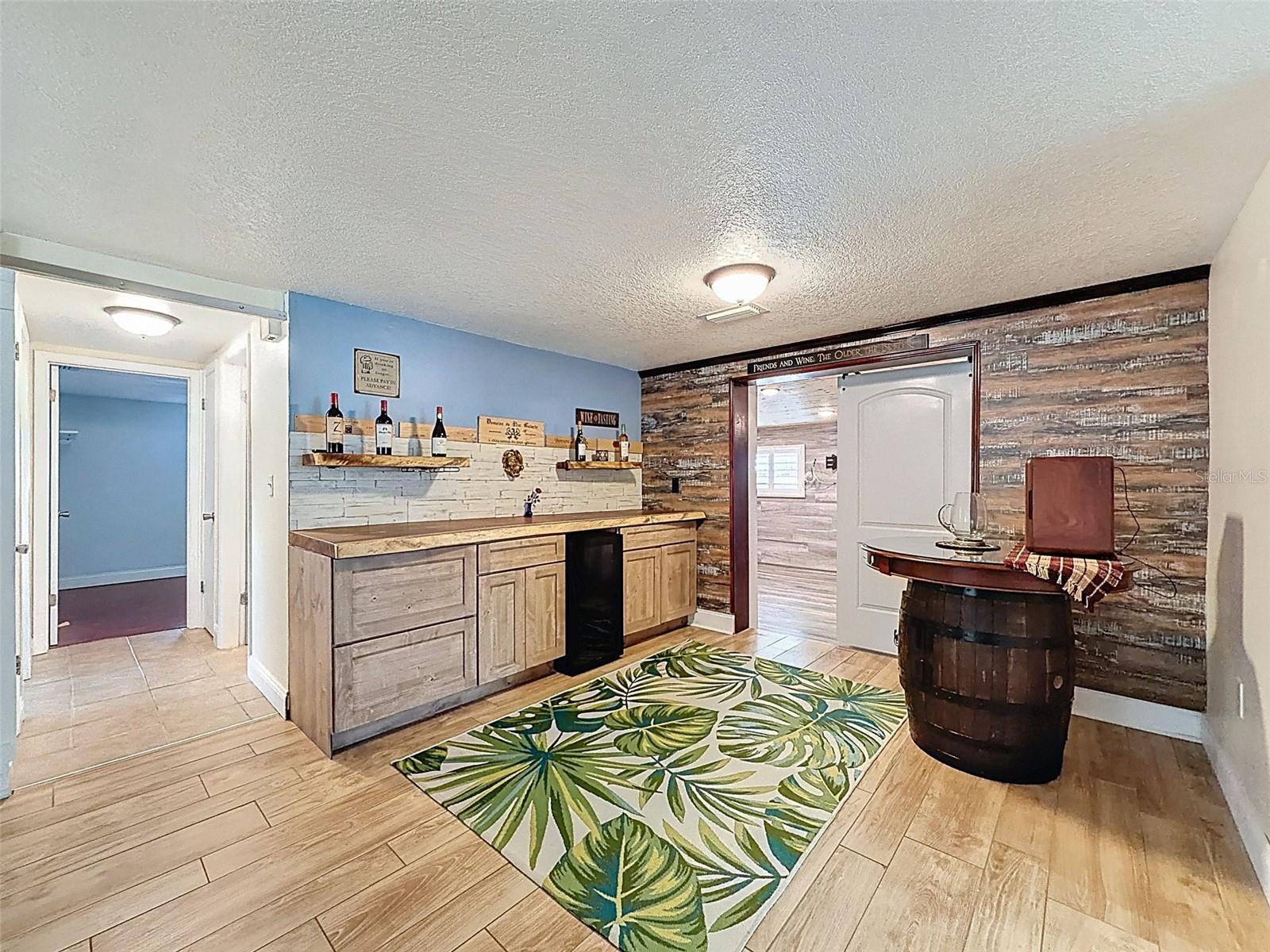 A BUILT IN BAR WITH BEVERAGE FRIDGE,