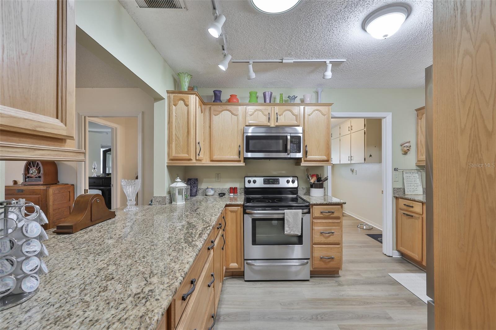 Updated Kitchen, Granite Countertops, Ample Wood Cabinets, Laundry to Garage
