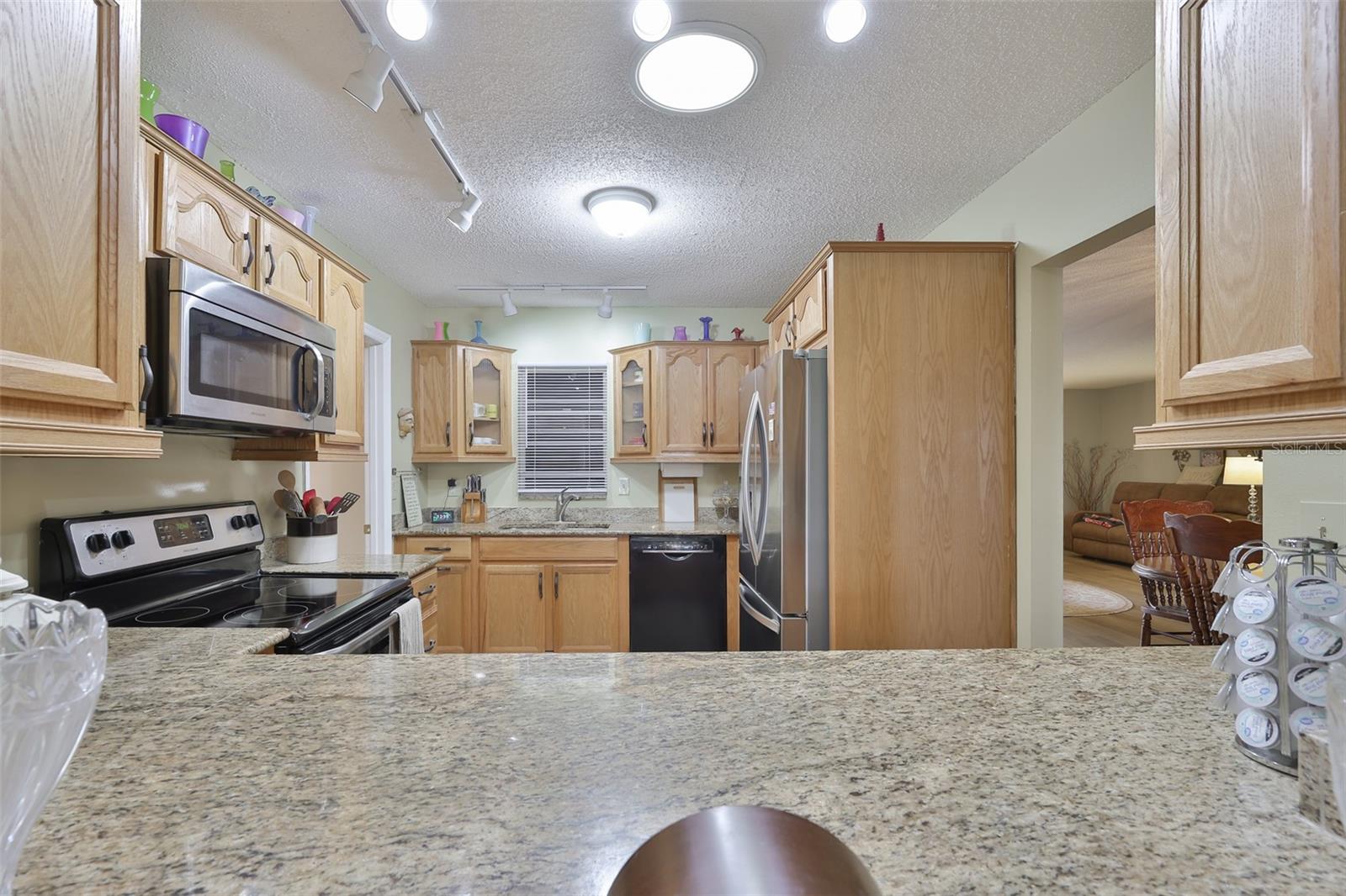 Granite Countertops, Breakfast Bar, Ample Wood Cabinets