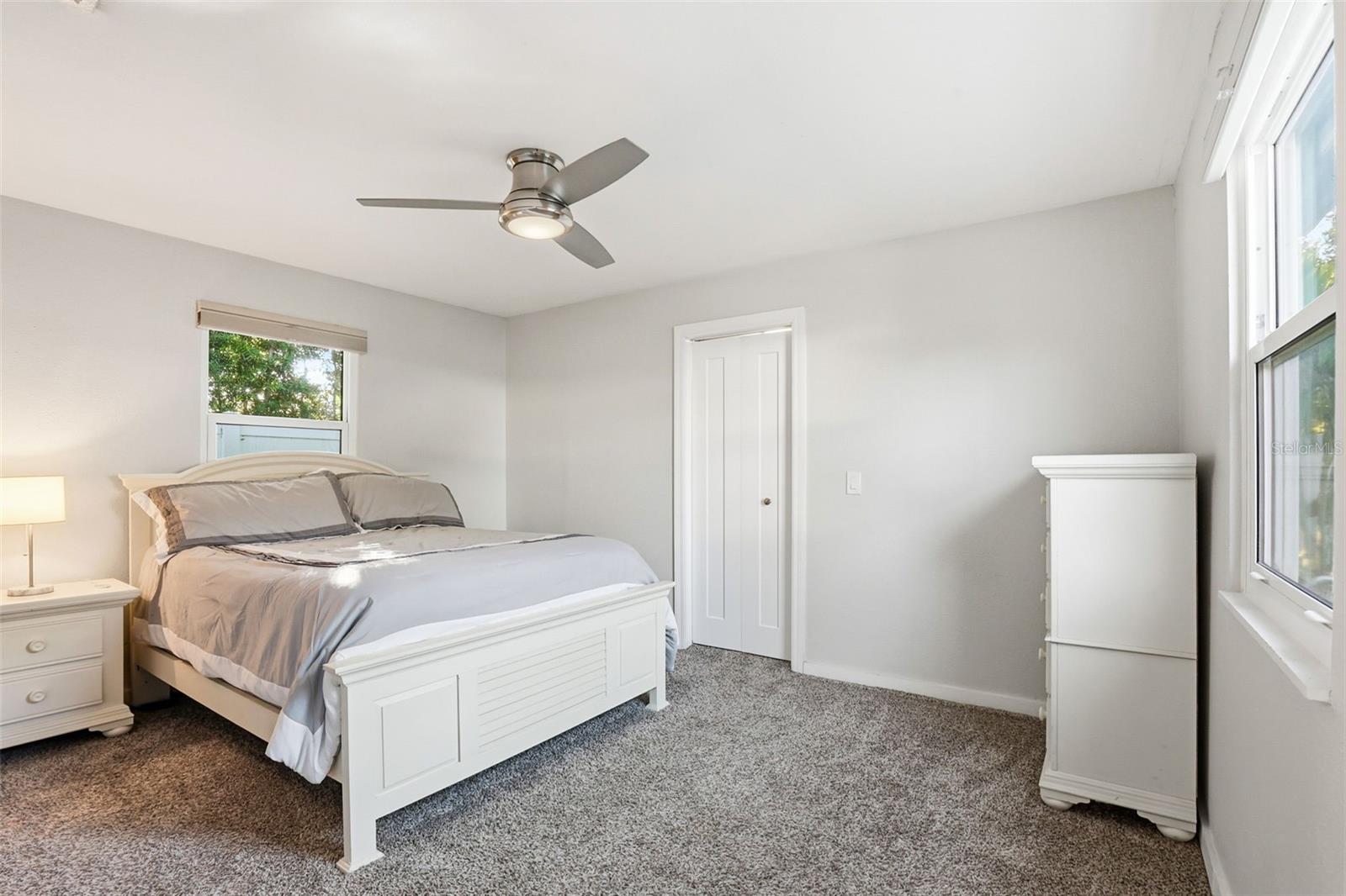 cozy primary bedroom with walk in closet
