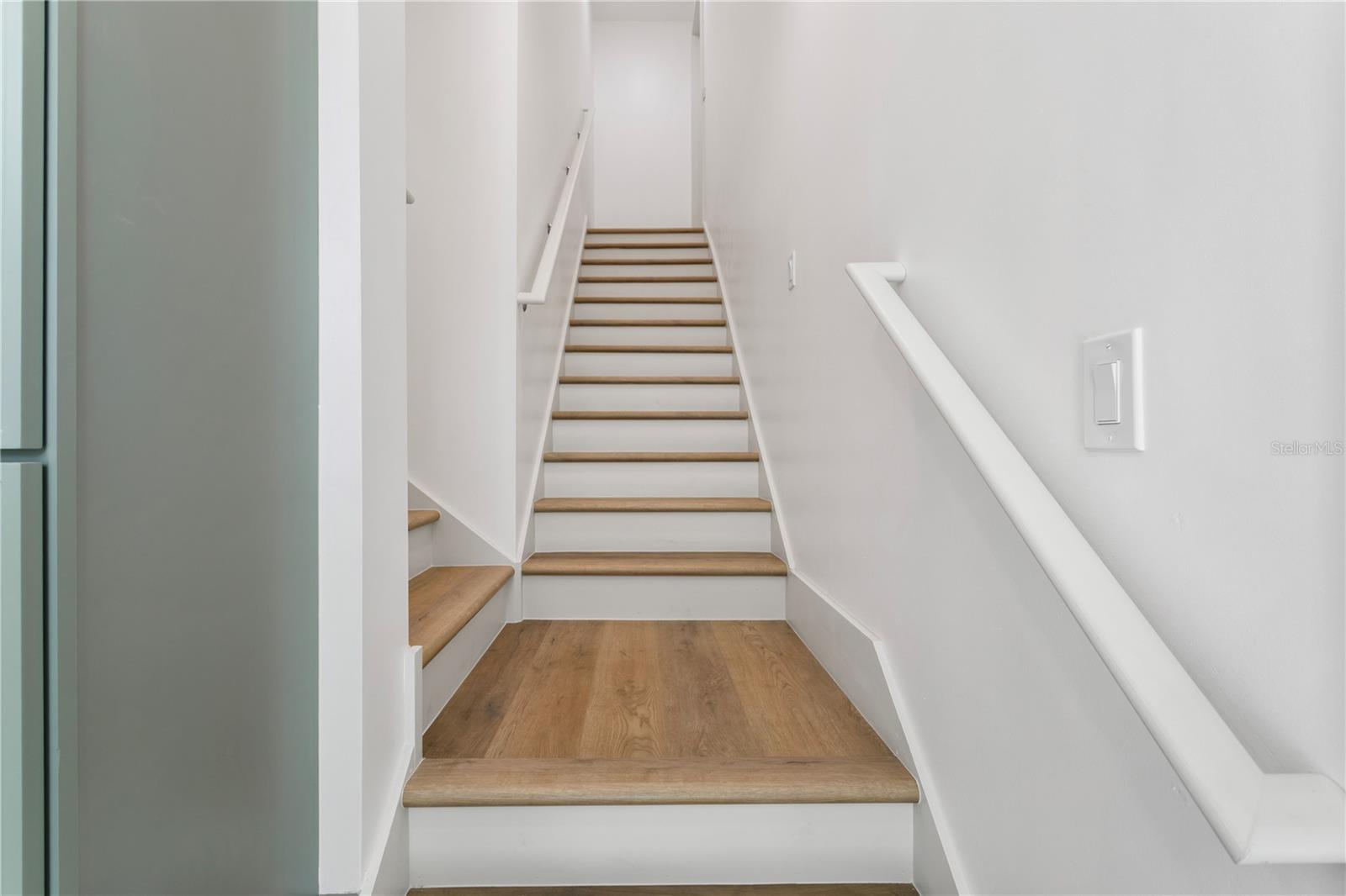 Hallway stairs to 2nd floor and space above garage