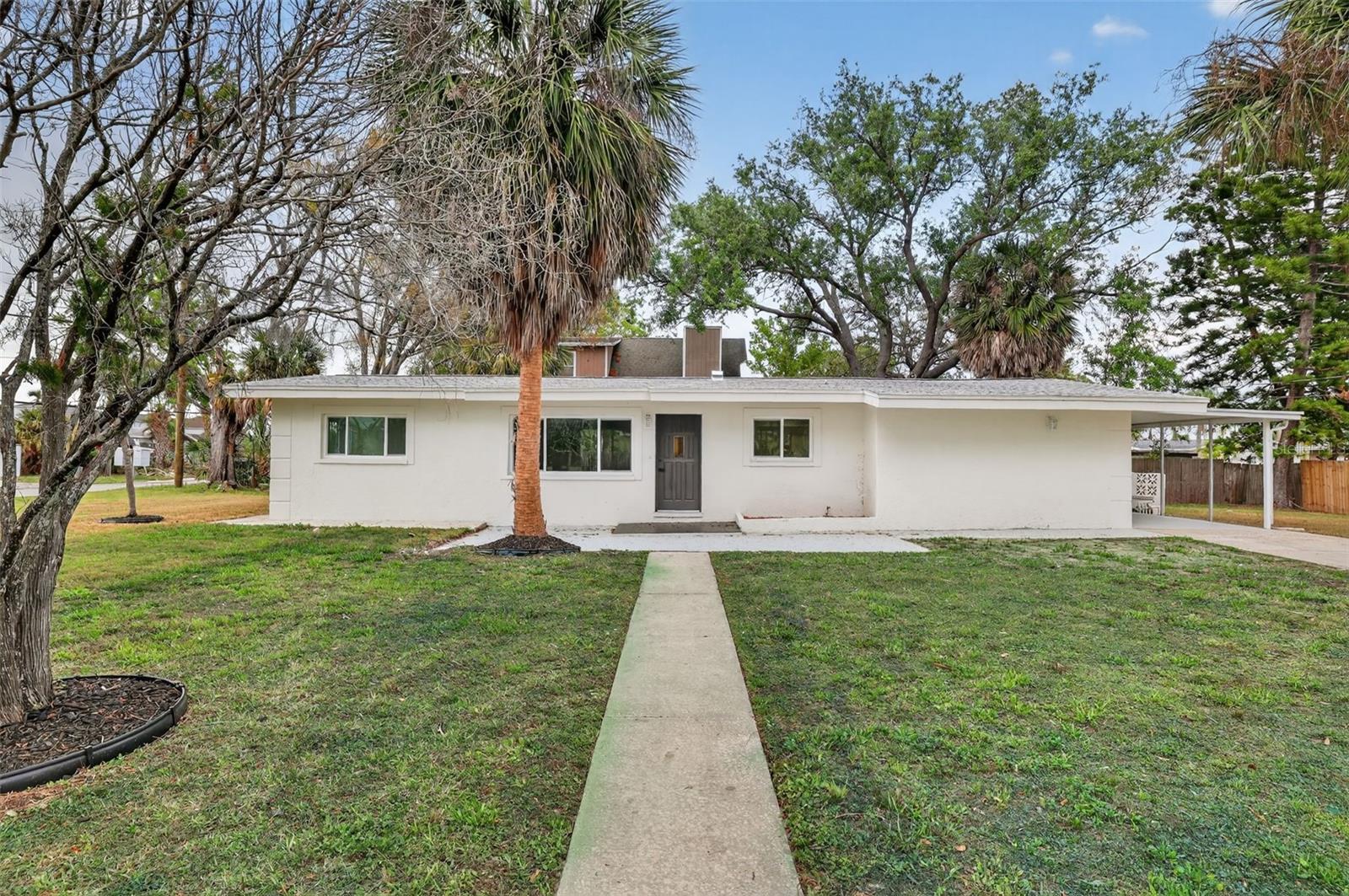 Updated Tarpon Springs home on a .22 Acre lot featuring coastal charm, modern improvements, and a spacious corner lot near boating, fishing, and Gulf Coast recreation
