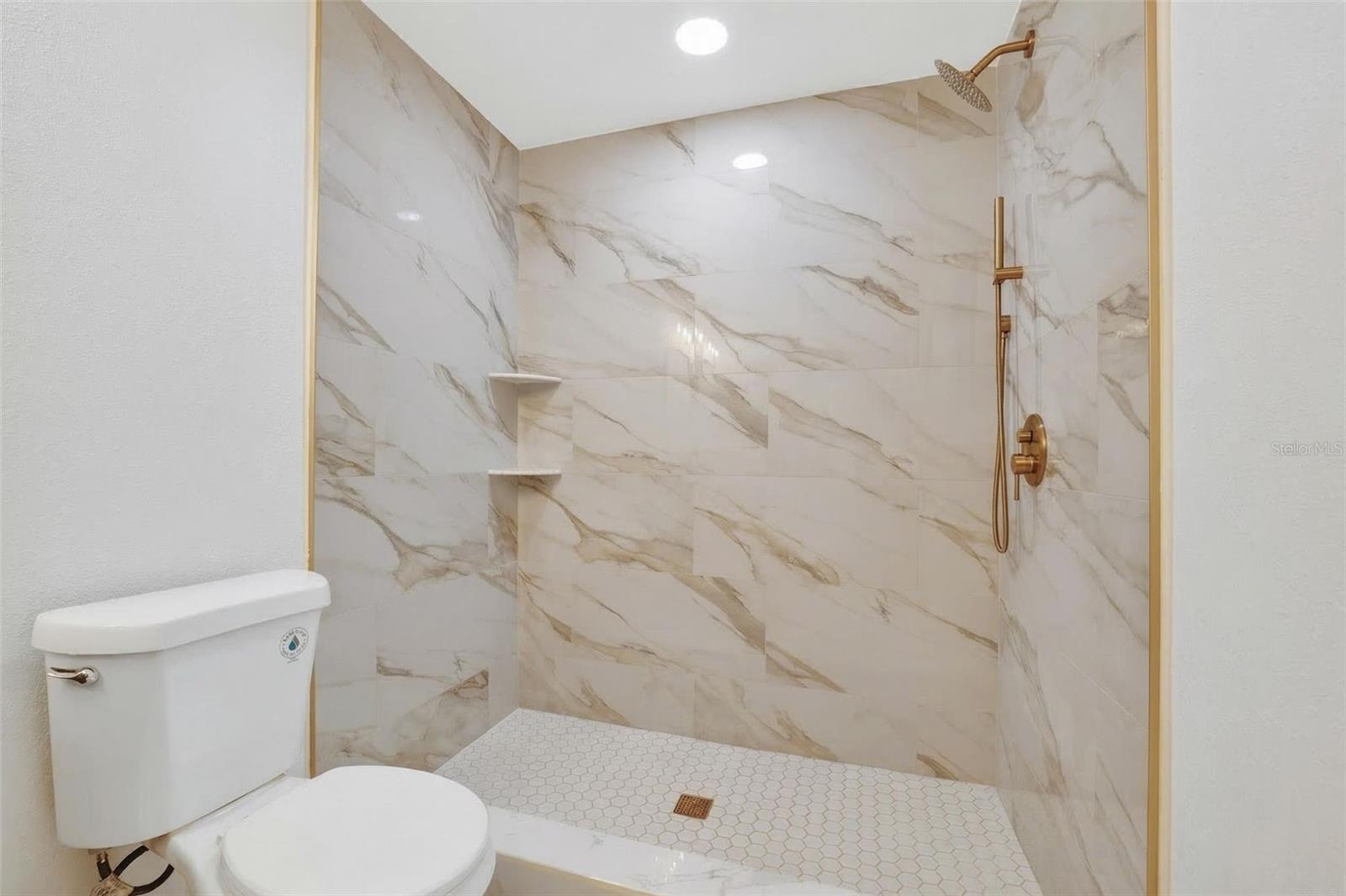 Designer walk in tiled shower with handheld shower wand