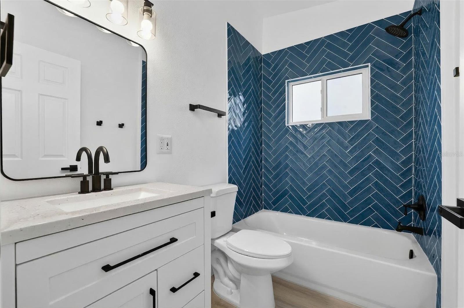Blue herringbone tile shower and tub combo