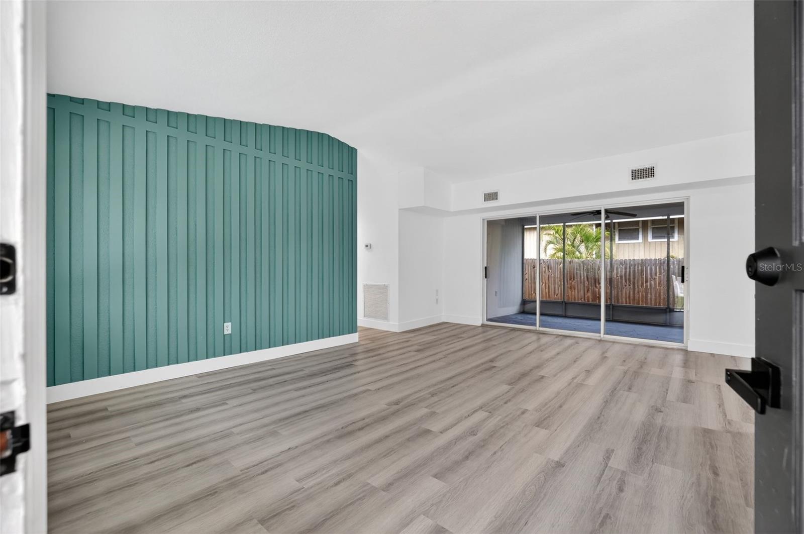 Sliding glass doors open to screened porch